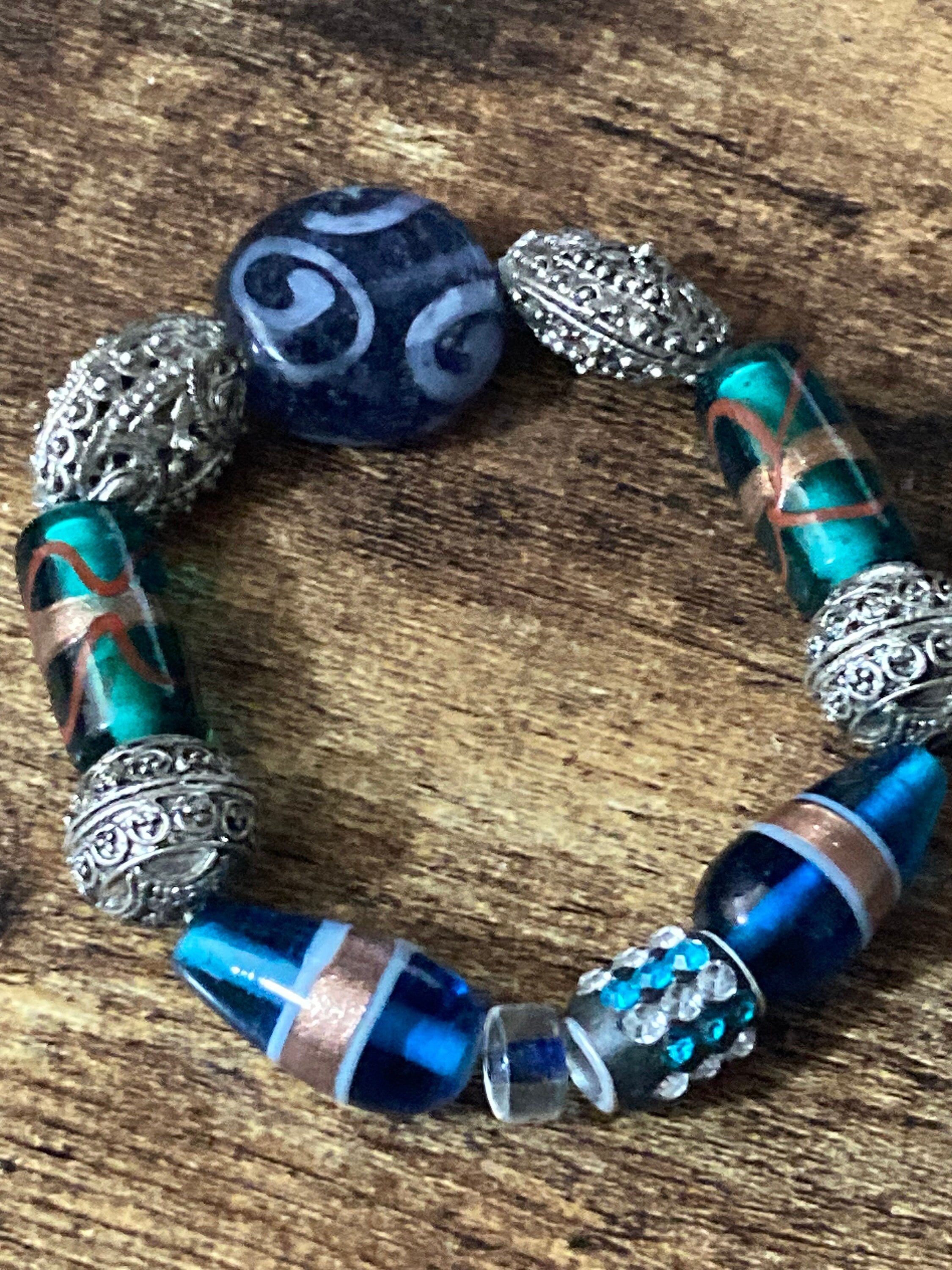 Beautiful blue hues and silver filigree and glass lamp work beaded stretch bracelet perfect for layering