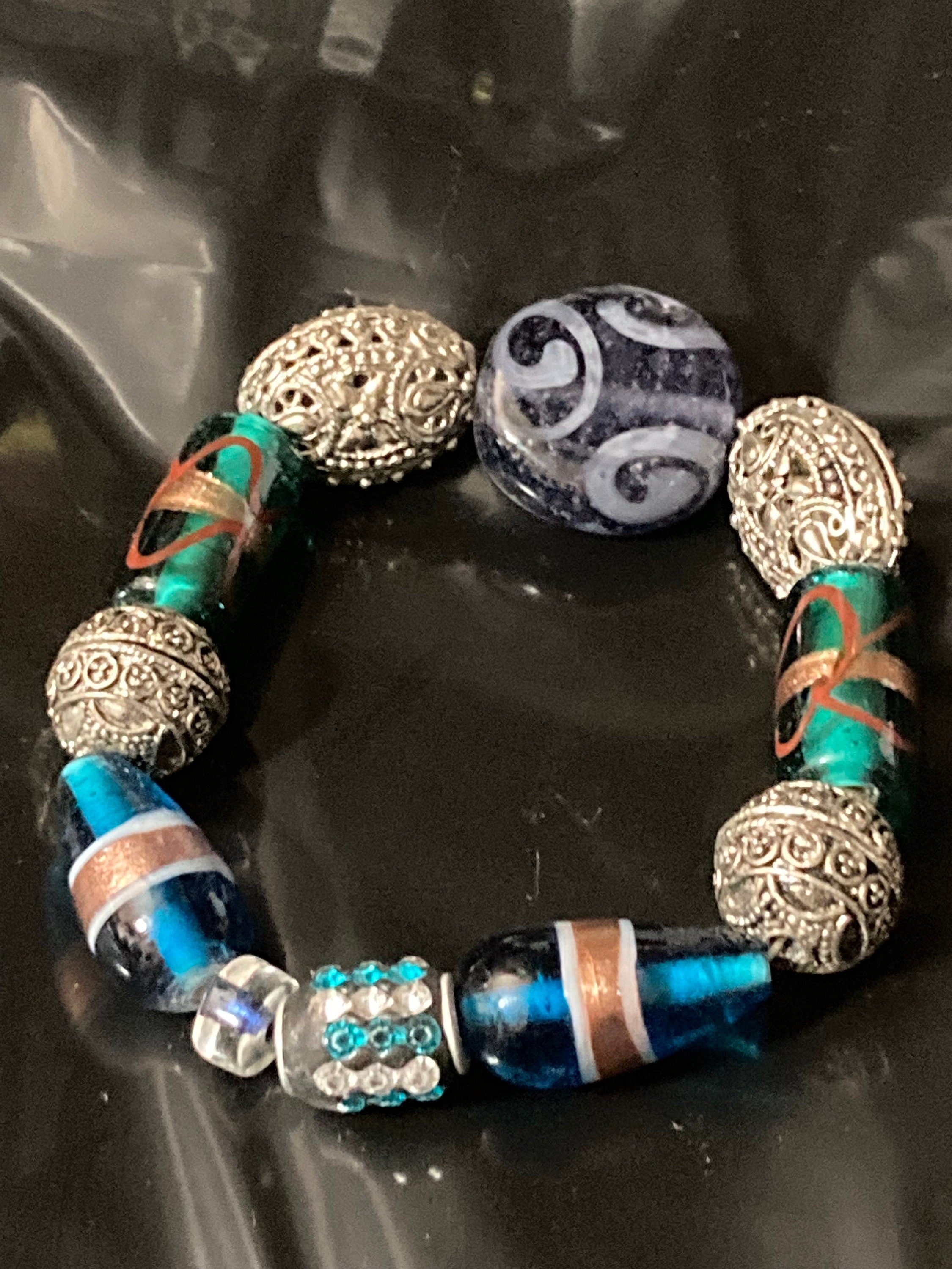 Beautiful blue hues and silver filigree and glass lamp work beaded stretch bracelet perfect for layering