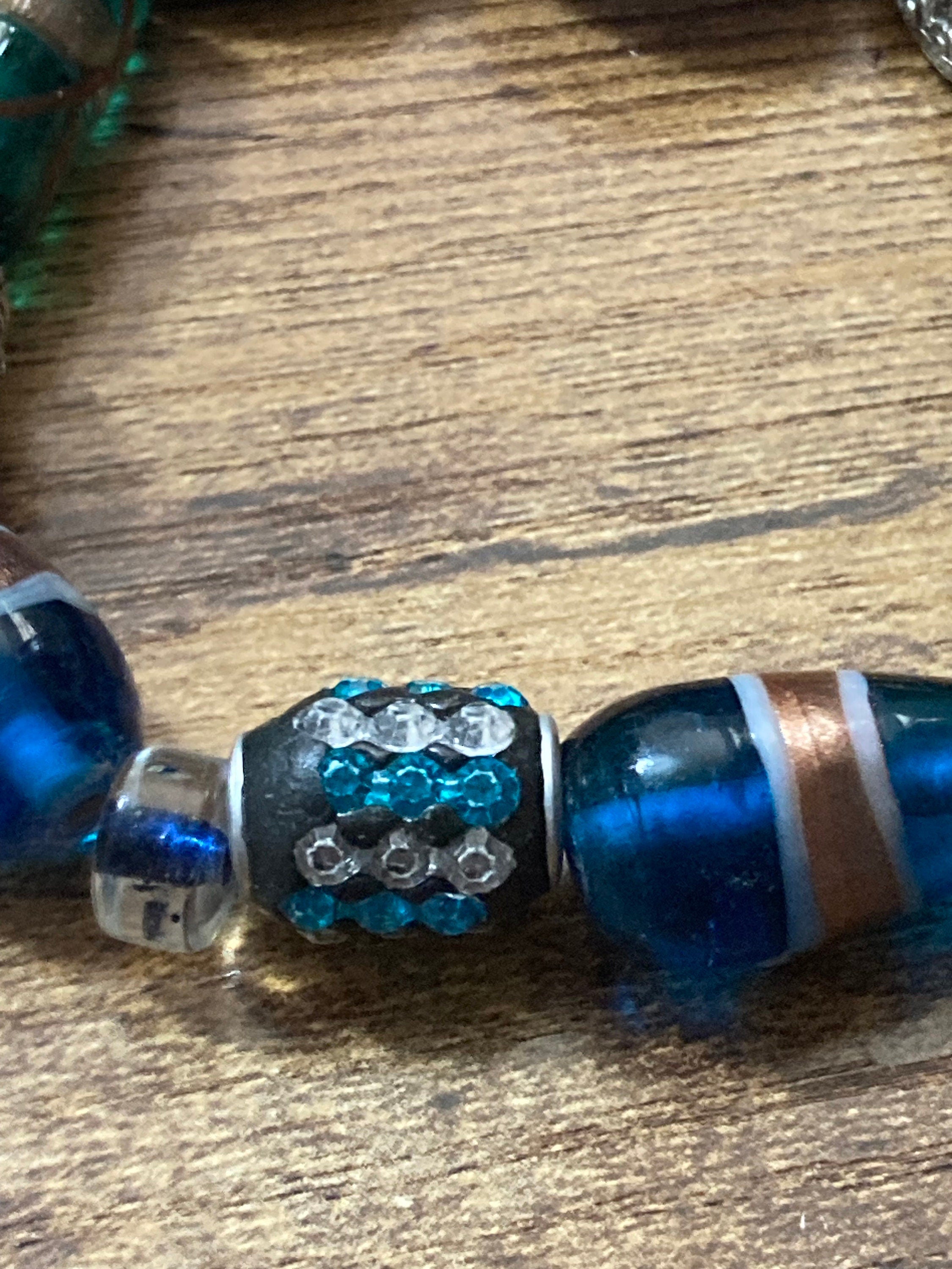 Beautiful blue hues and silver filigree and glass lamp work beaded stretch bracelet perfect for layering