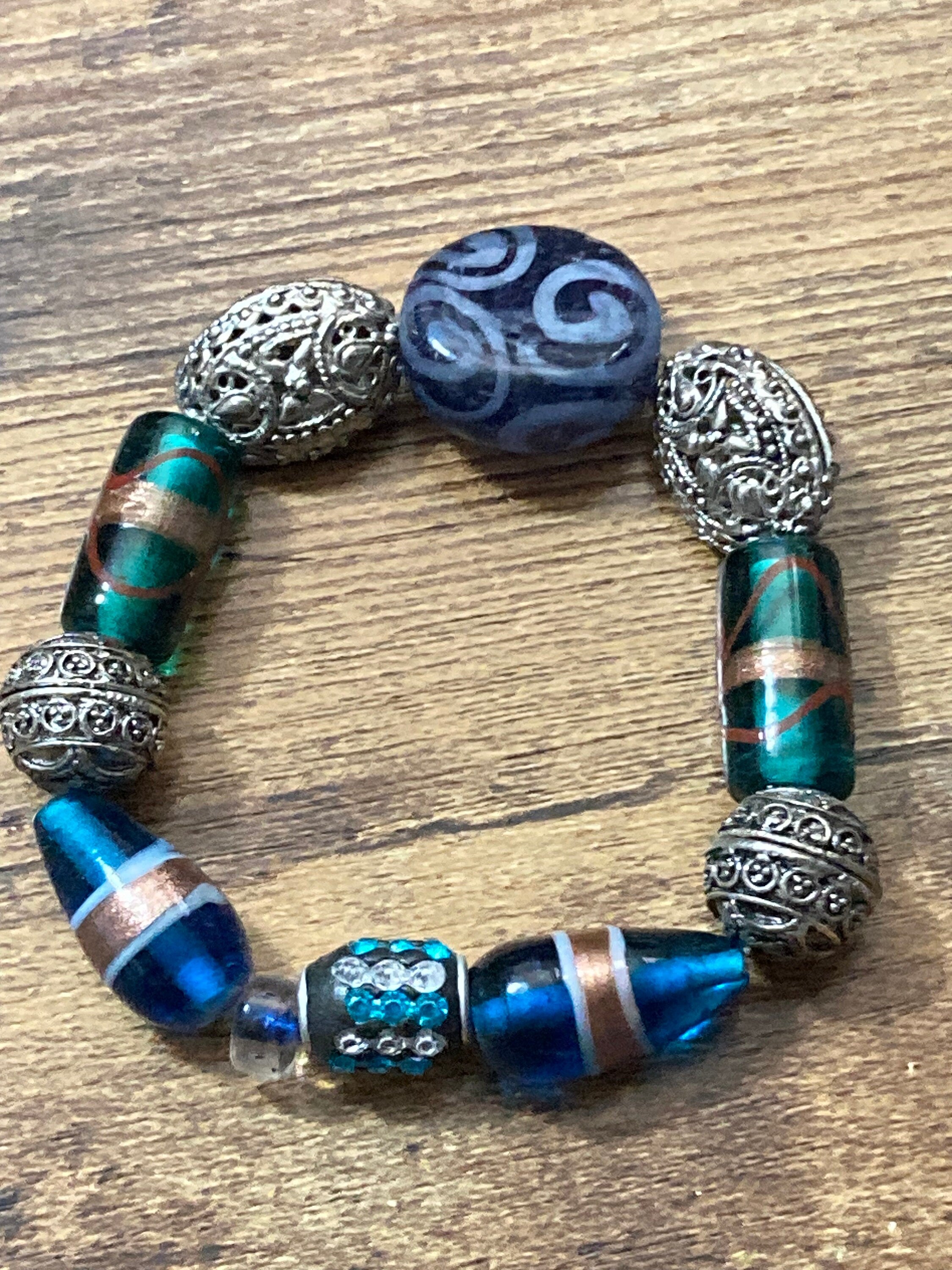 Beautiful blue hues and silver filigree and glass lamp work beaded stretch bracelet perfect for layering