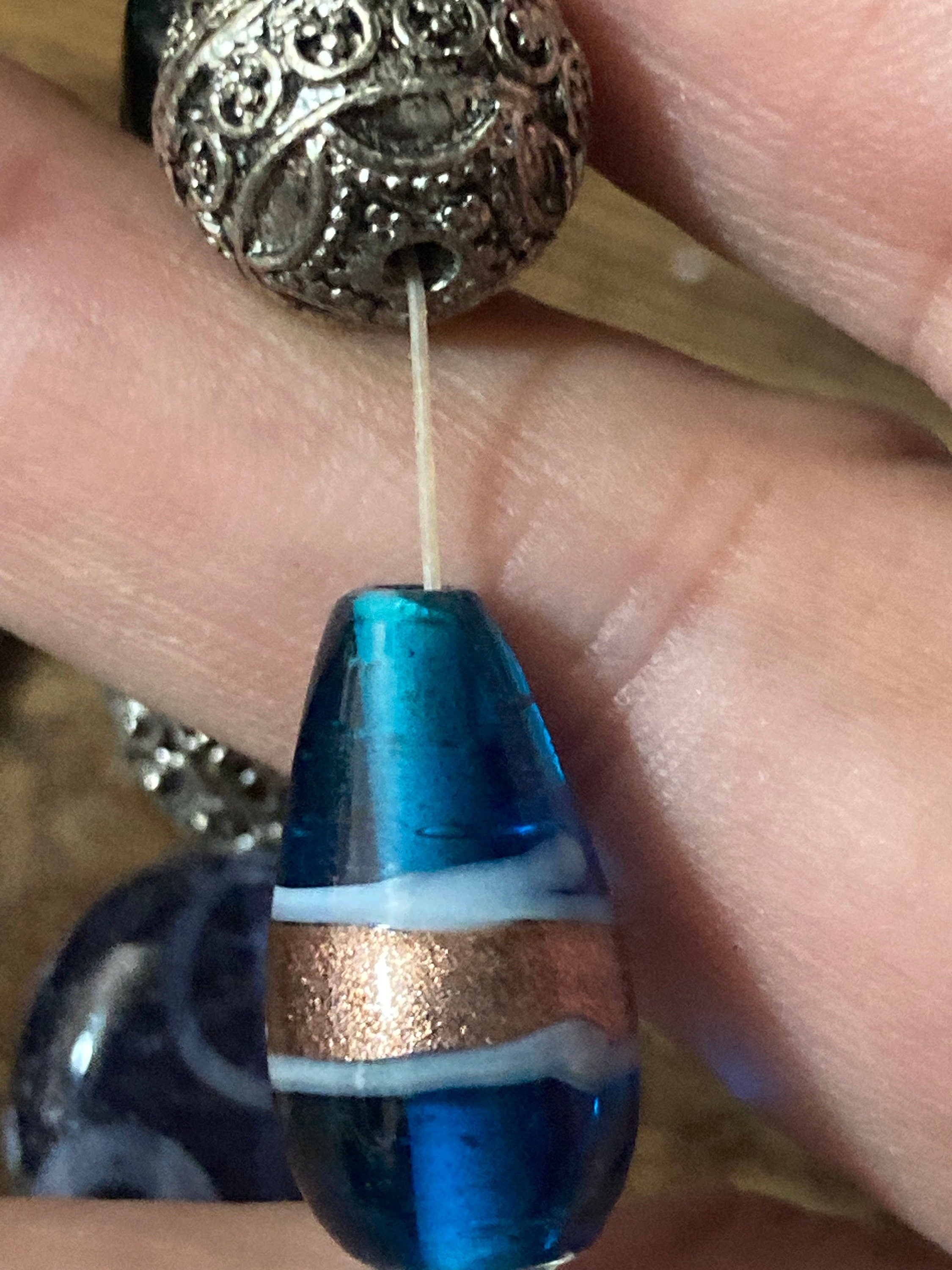 Beautiful blue hues and silver filigree and glass lamp work beaded stretch bracelet perfect for layering
