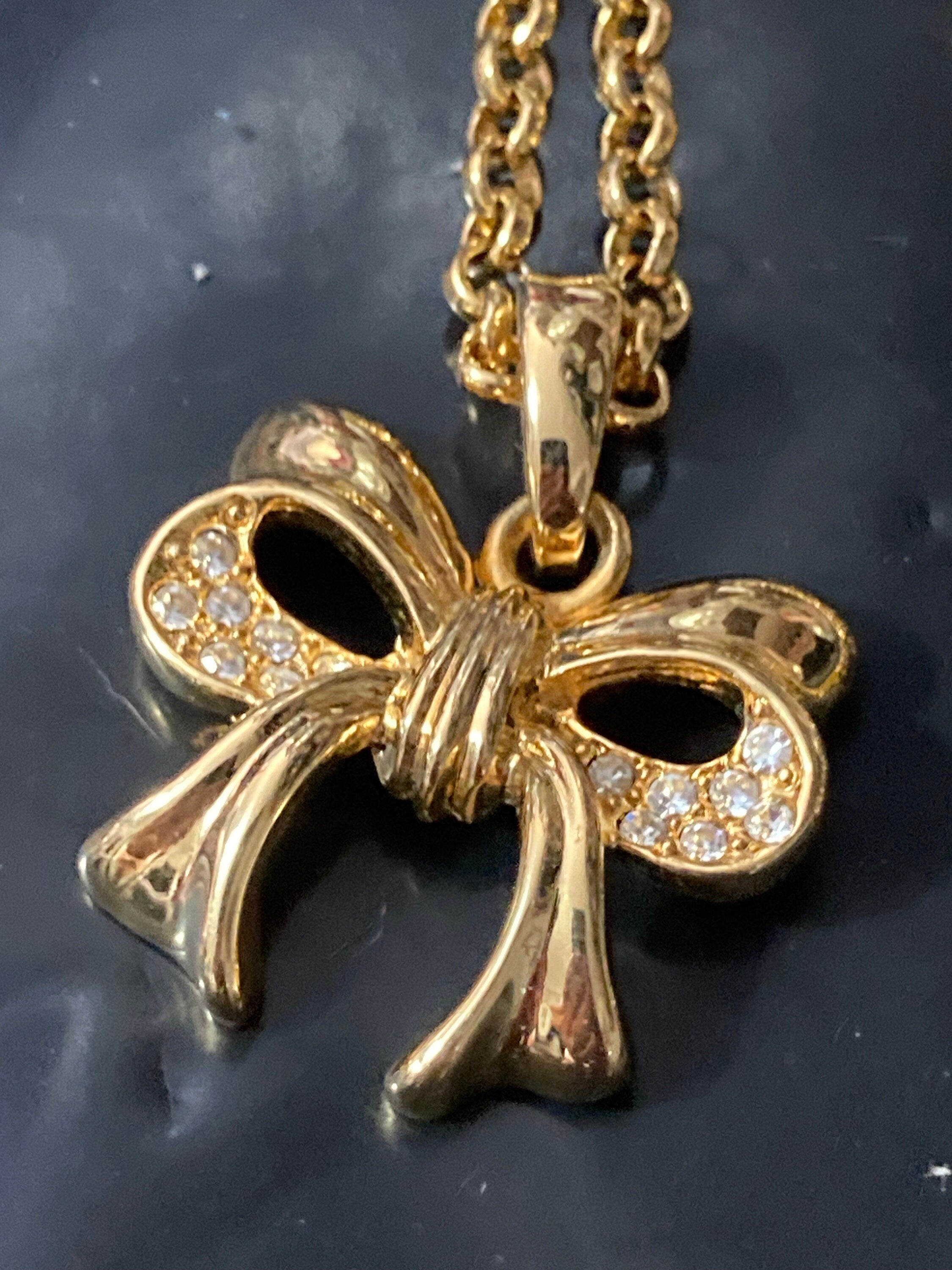 Signed Joan Rivers gold plated clear diamanté bow pendant necklace