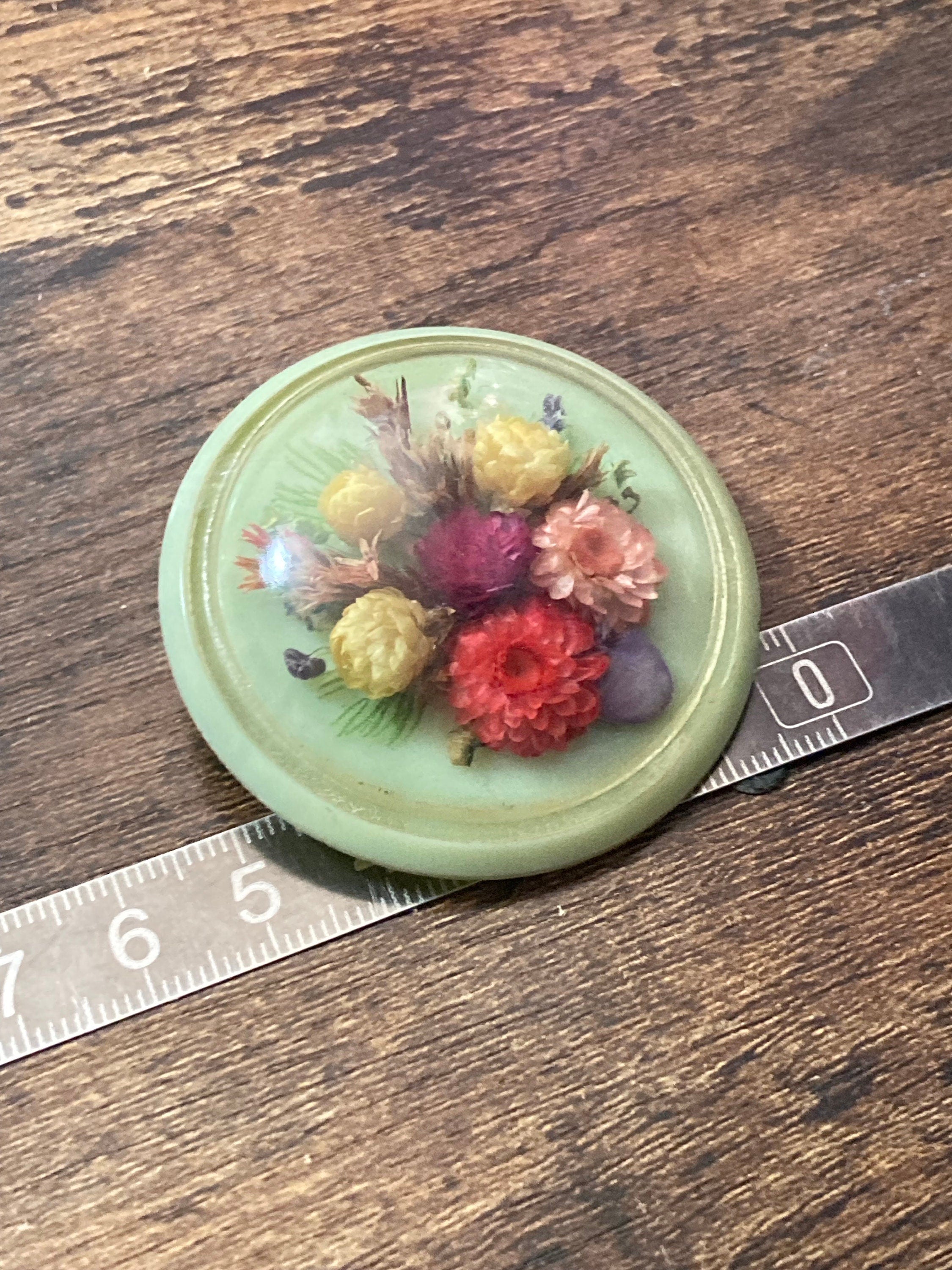 Vintage kitsch soft green early plastic celluloid domed dried pressed flowers floral bouquet brooch 1930s