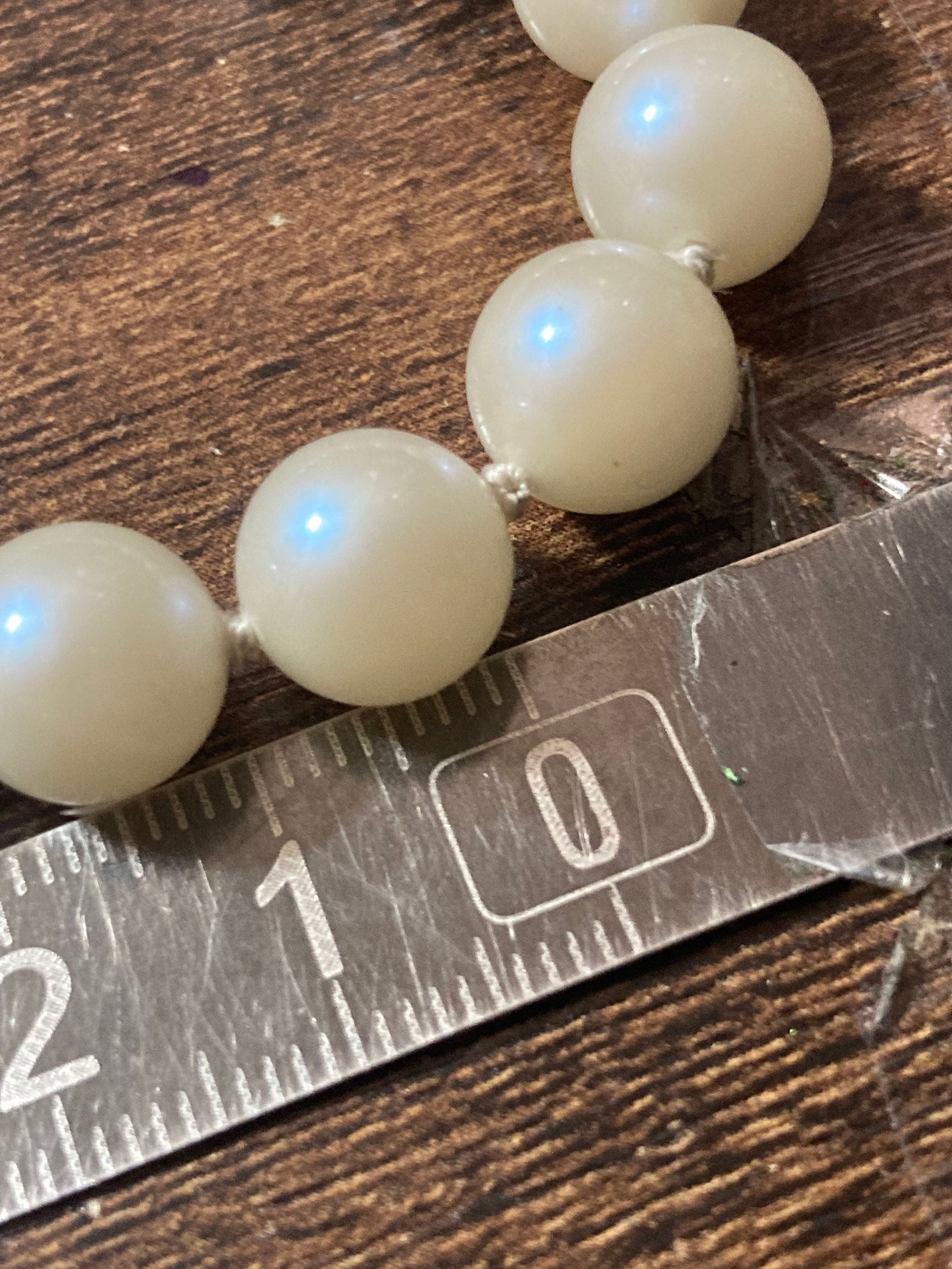 Vintage white faux pearl double strand necklace with emerald paste clasp