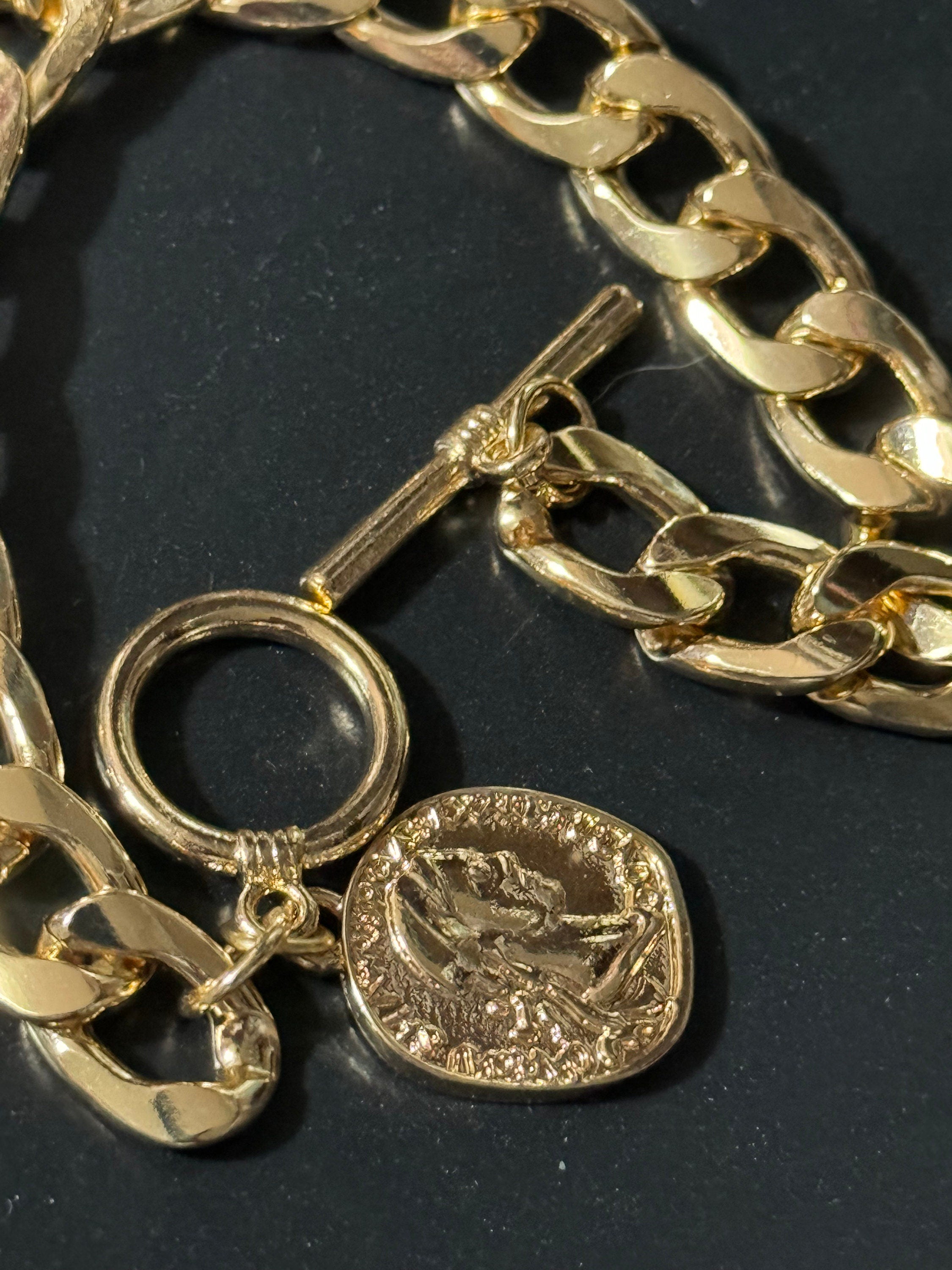 Retro gold tone chain link curb bracelet with faux medallion coin charm