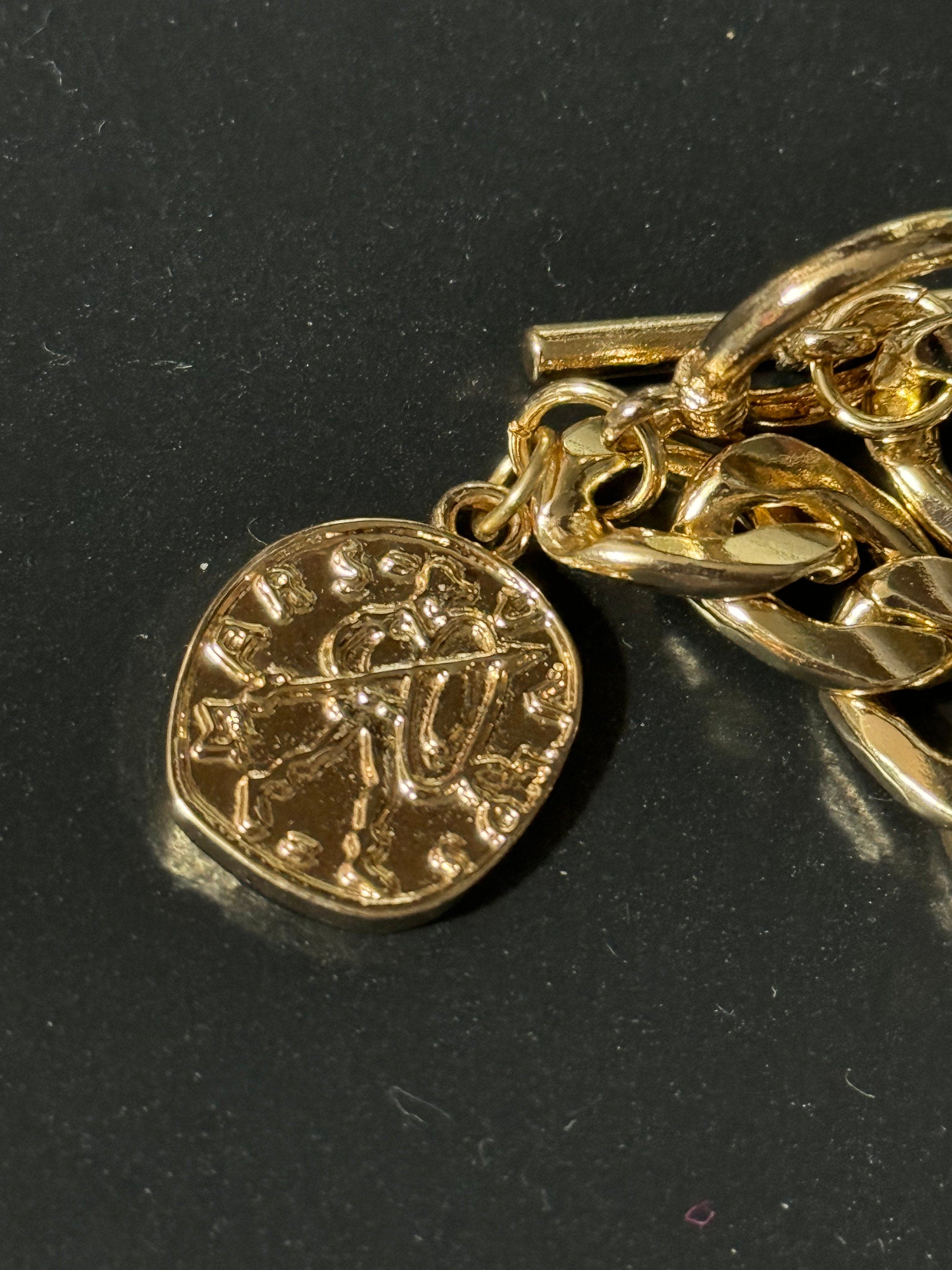 Retro gold tone chain link curb bracelet with faux medallion coin charm