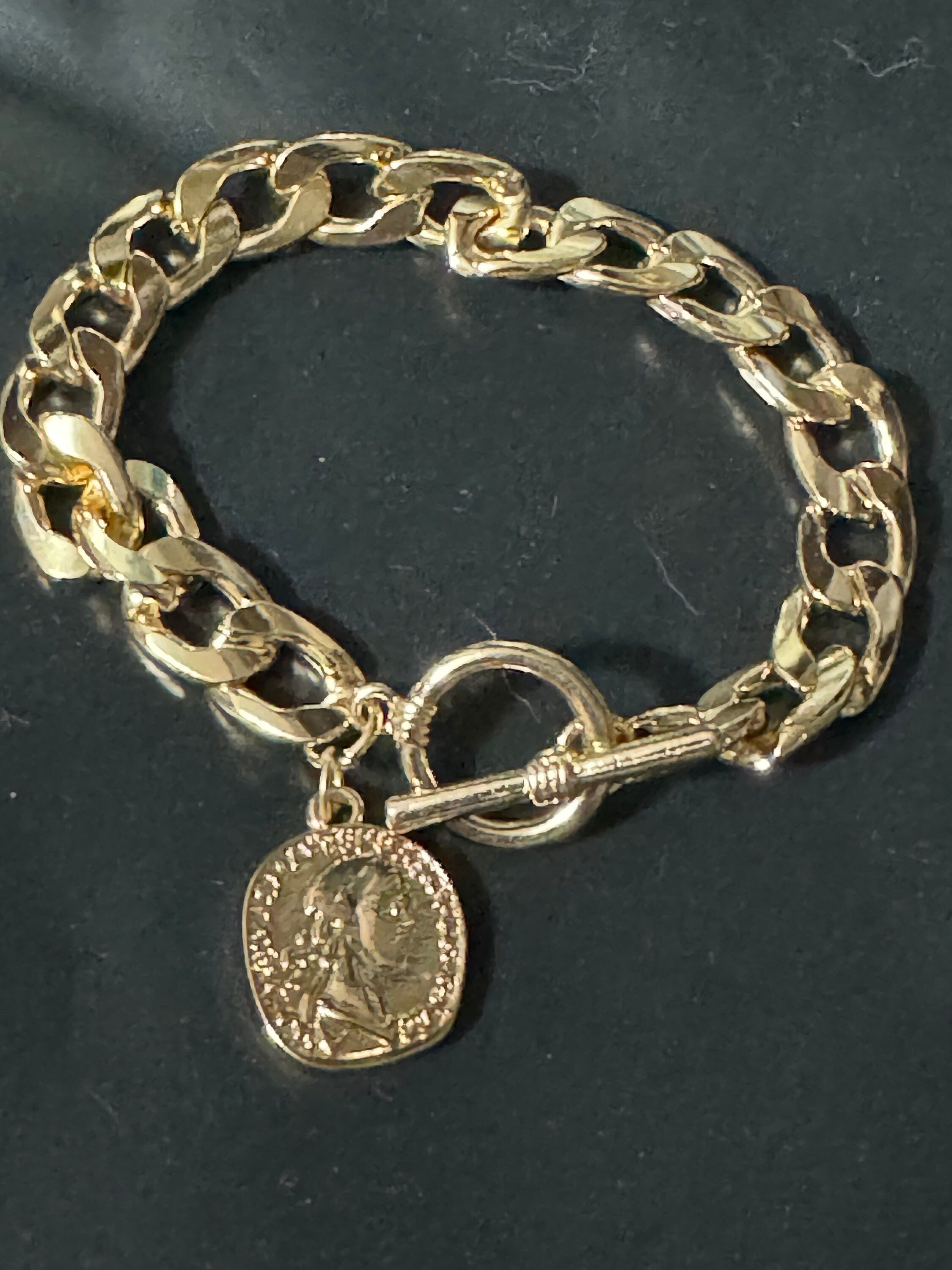 Retro gold tone chain link curb bracelet with faux medallion coin charm