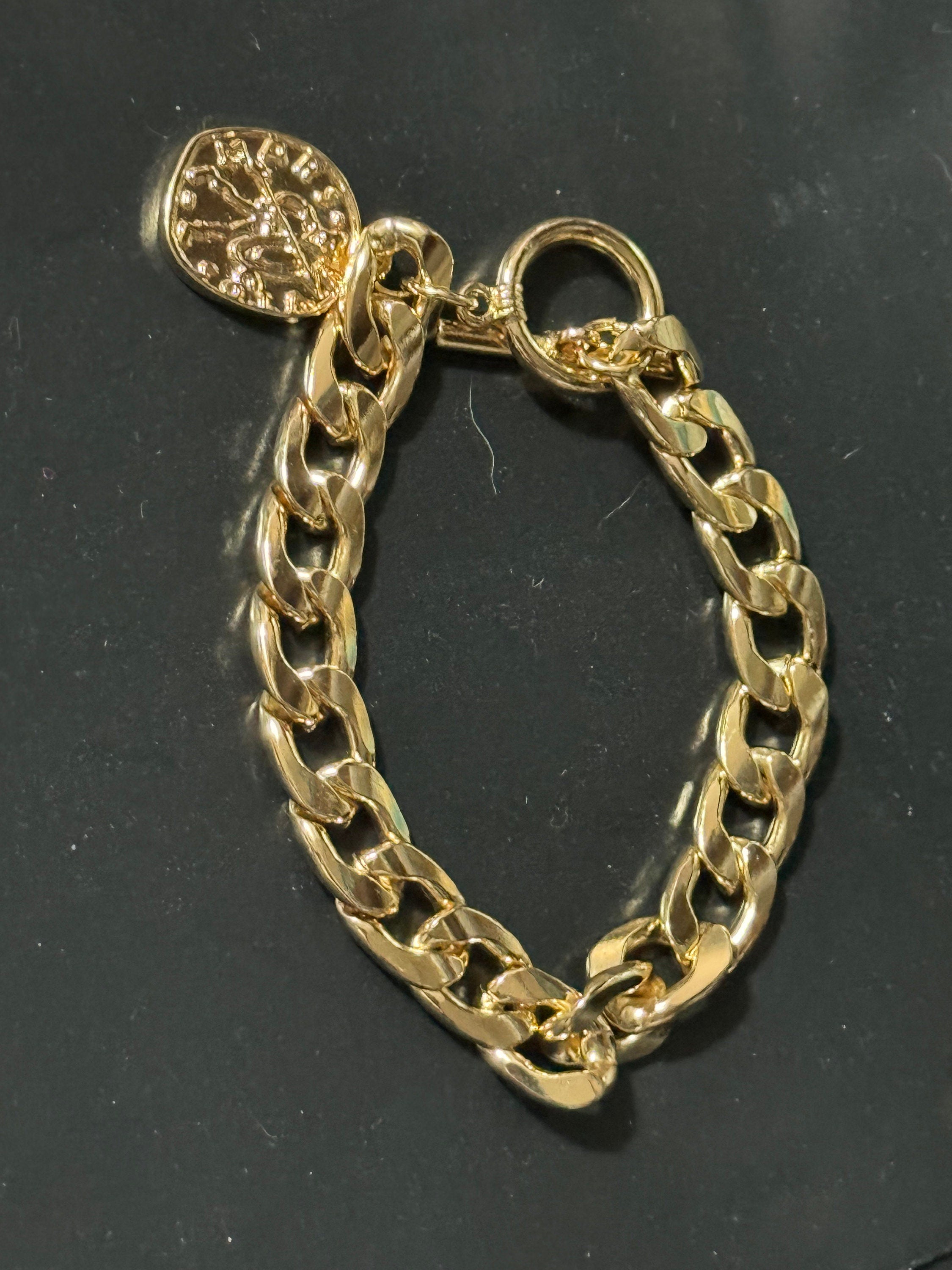 Retro gold tone chain link curb bracelet with faux medallion coin charm