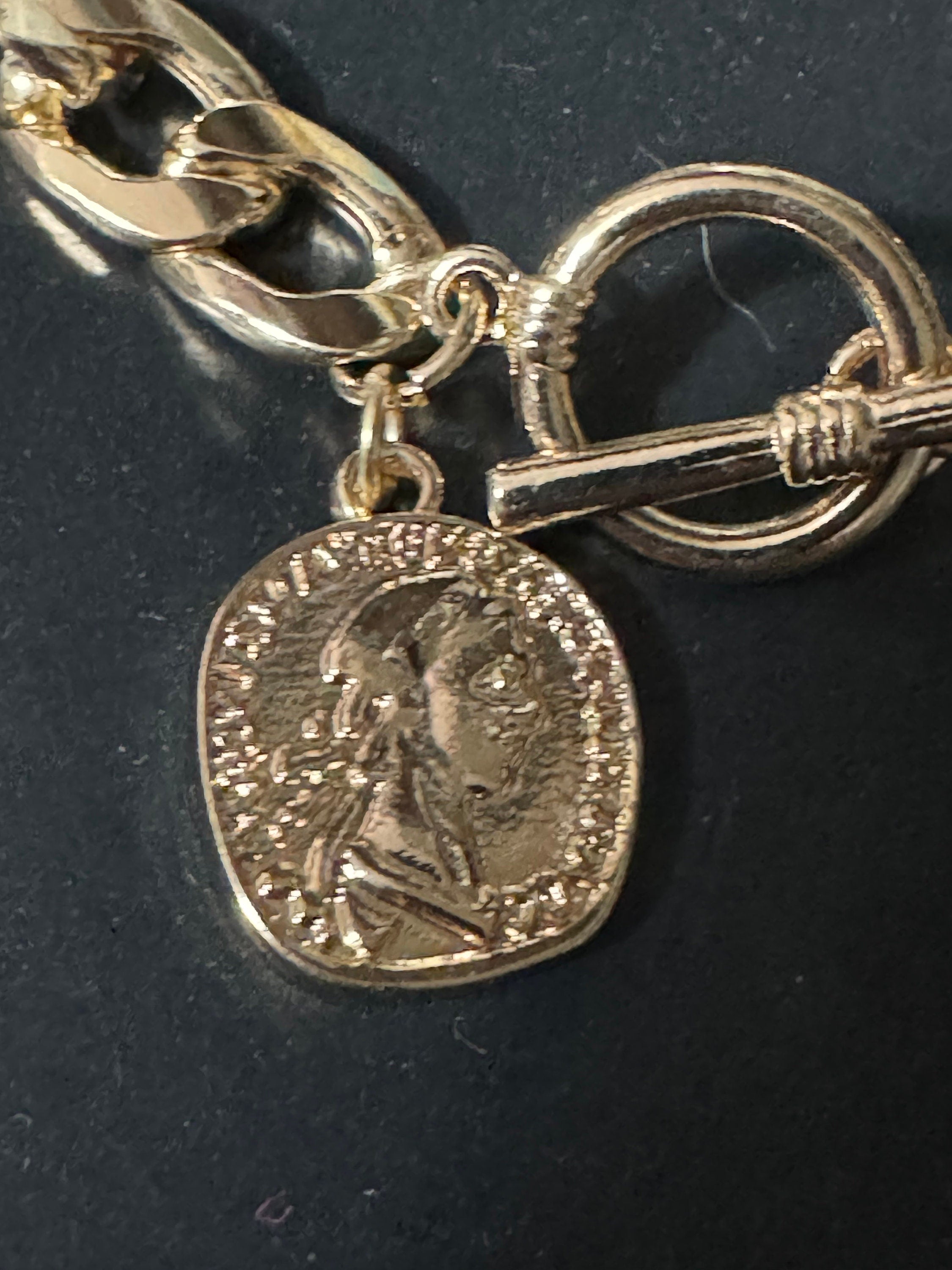Retro gold tone chain link curb bracelet with faux medallion coin charm