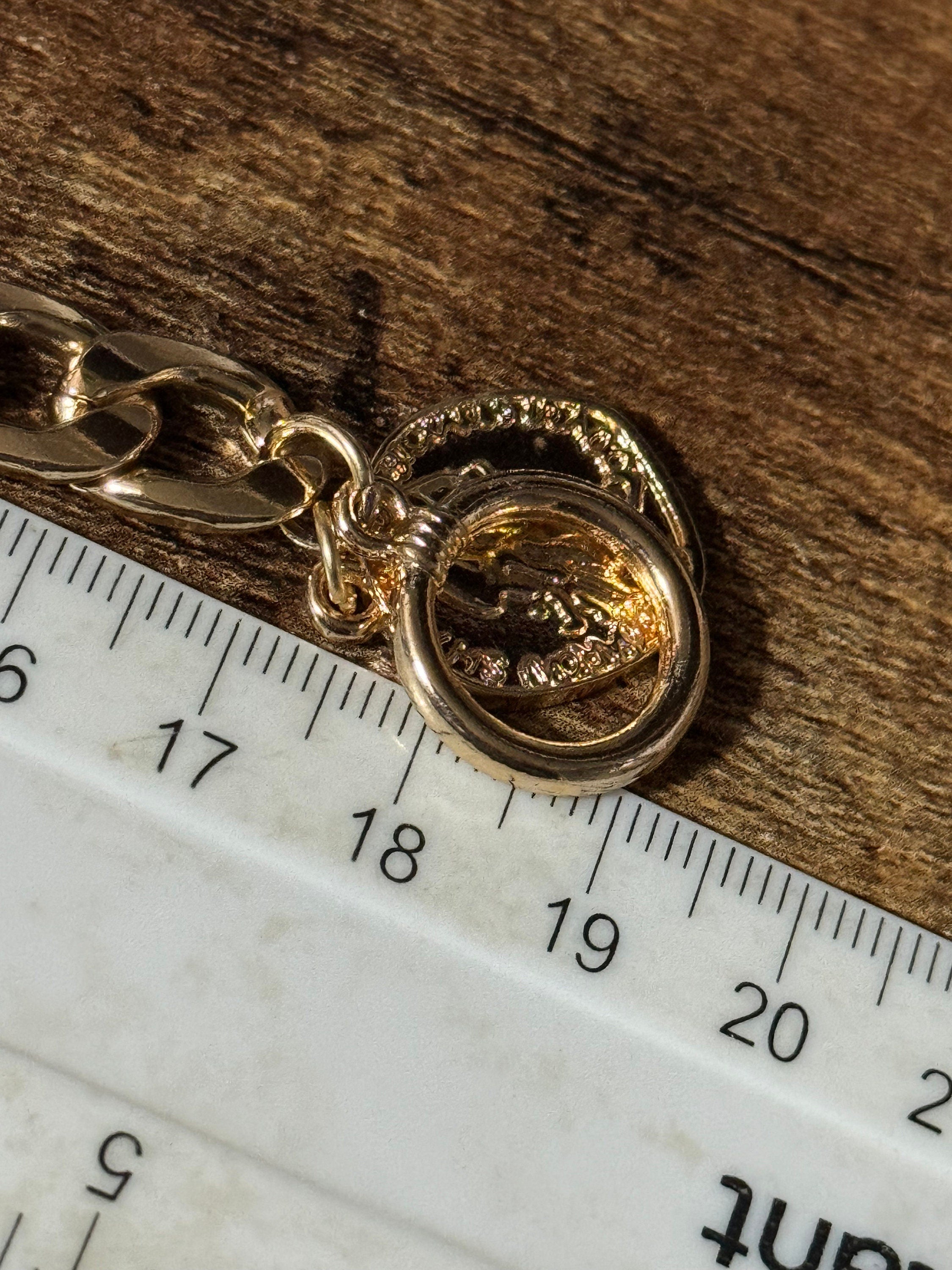 Retro gold tone chain link curb bracelet with faux medallion coin charm