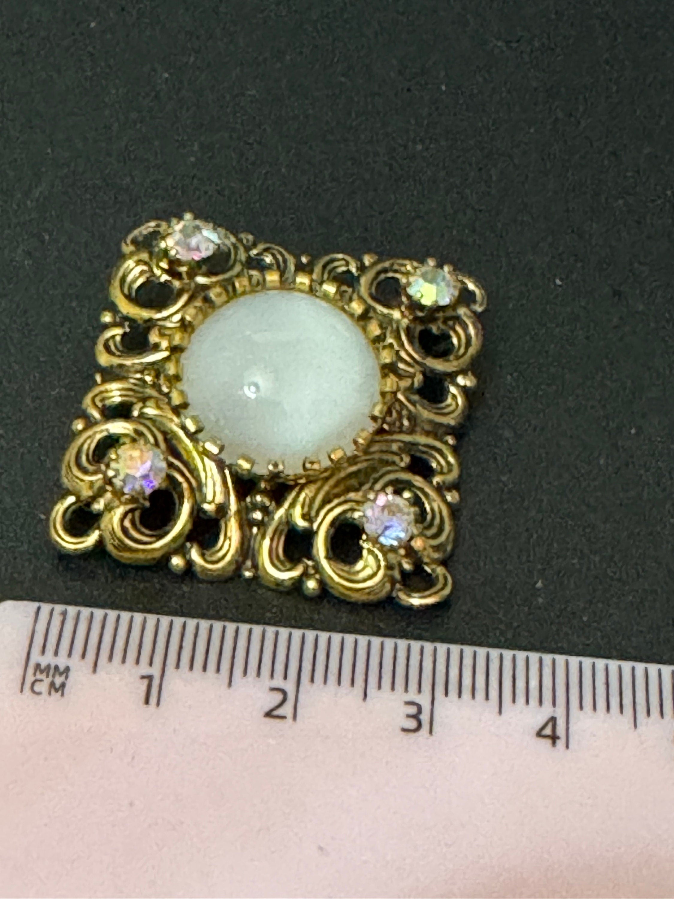 Antique Art Deco Czech brass gilt metal filigree brooch with white glass cabochon and AB rhinestones