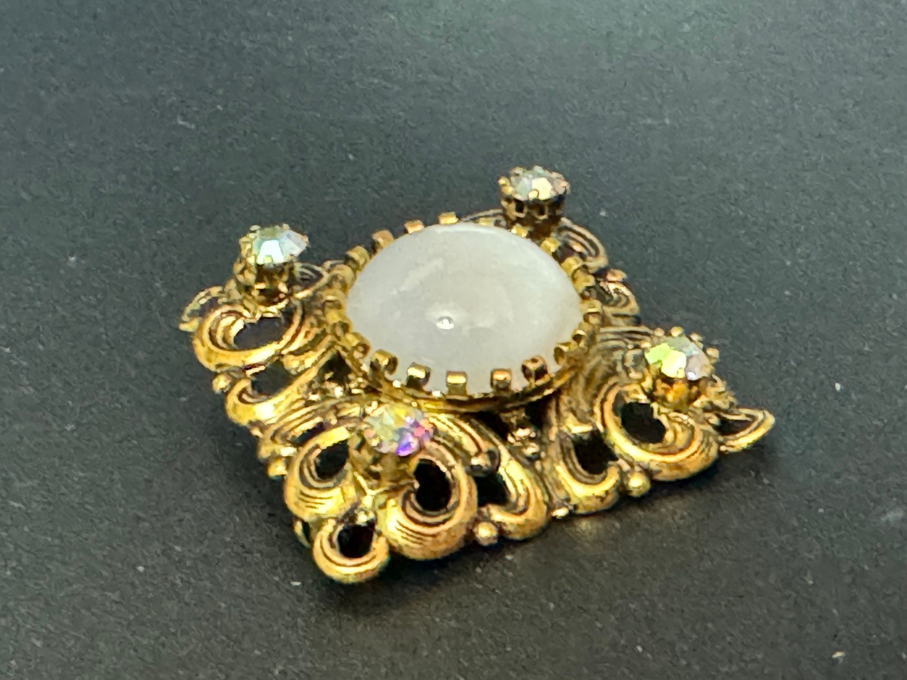 Antique Art Deco Czech brass gilt metal filigree brooch with white glass cabochon and AB rhinestones