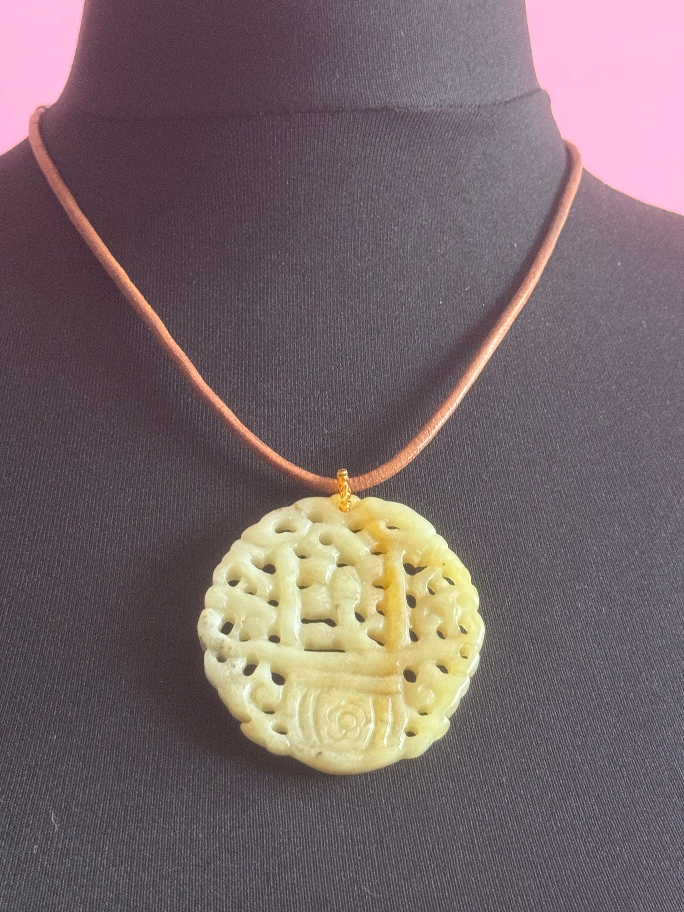 Signed Joan Rivers oversized carved light green brown jade Chinese pendant necklace on leather thong
