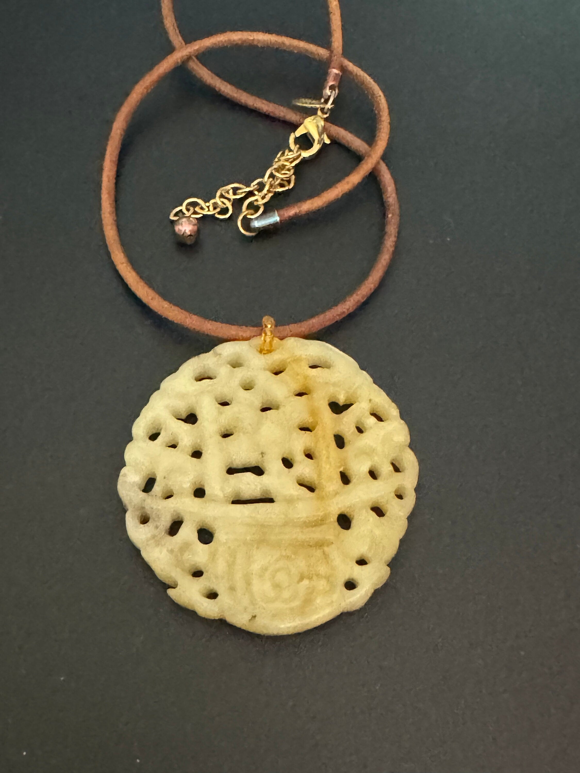 Signed Joan Rivers oversized carved light green brown jade Chinese pendant necklace on leather thong