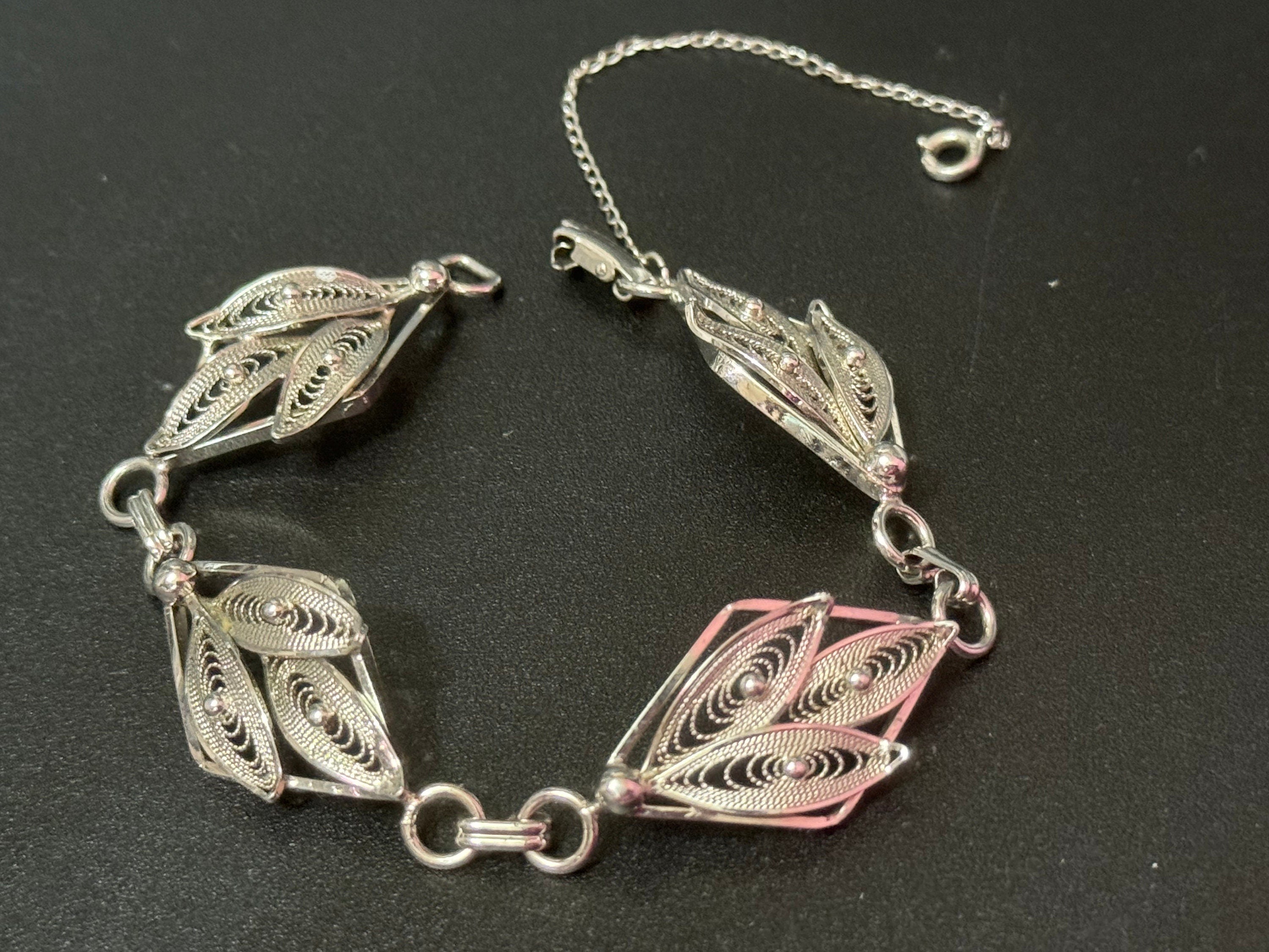 Silver tone fine filigree work panel link bracelet with safety chain