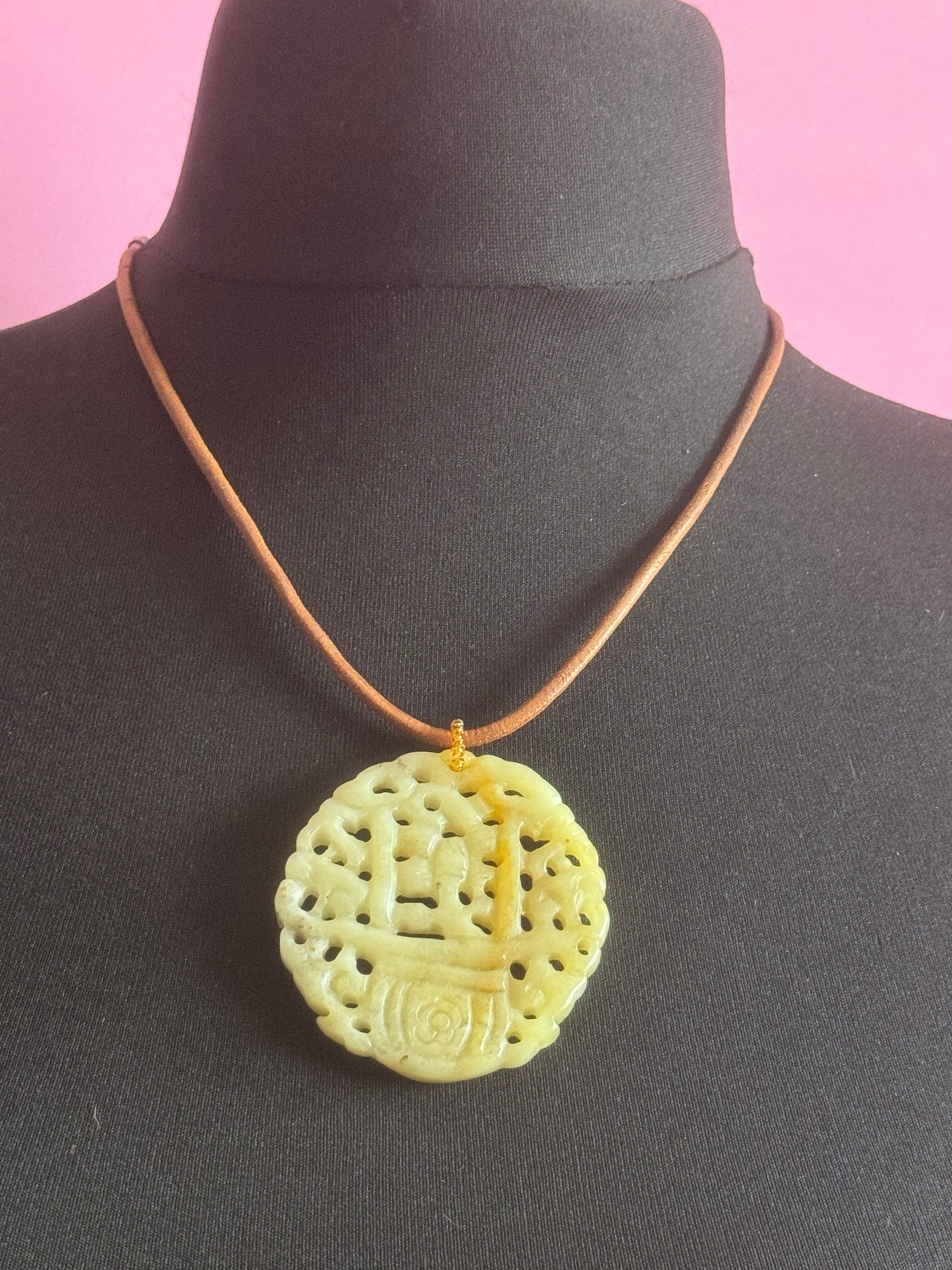 Signed Joan Rivers oversized carved light green brown jade Chinese pendant necklace on leather thong