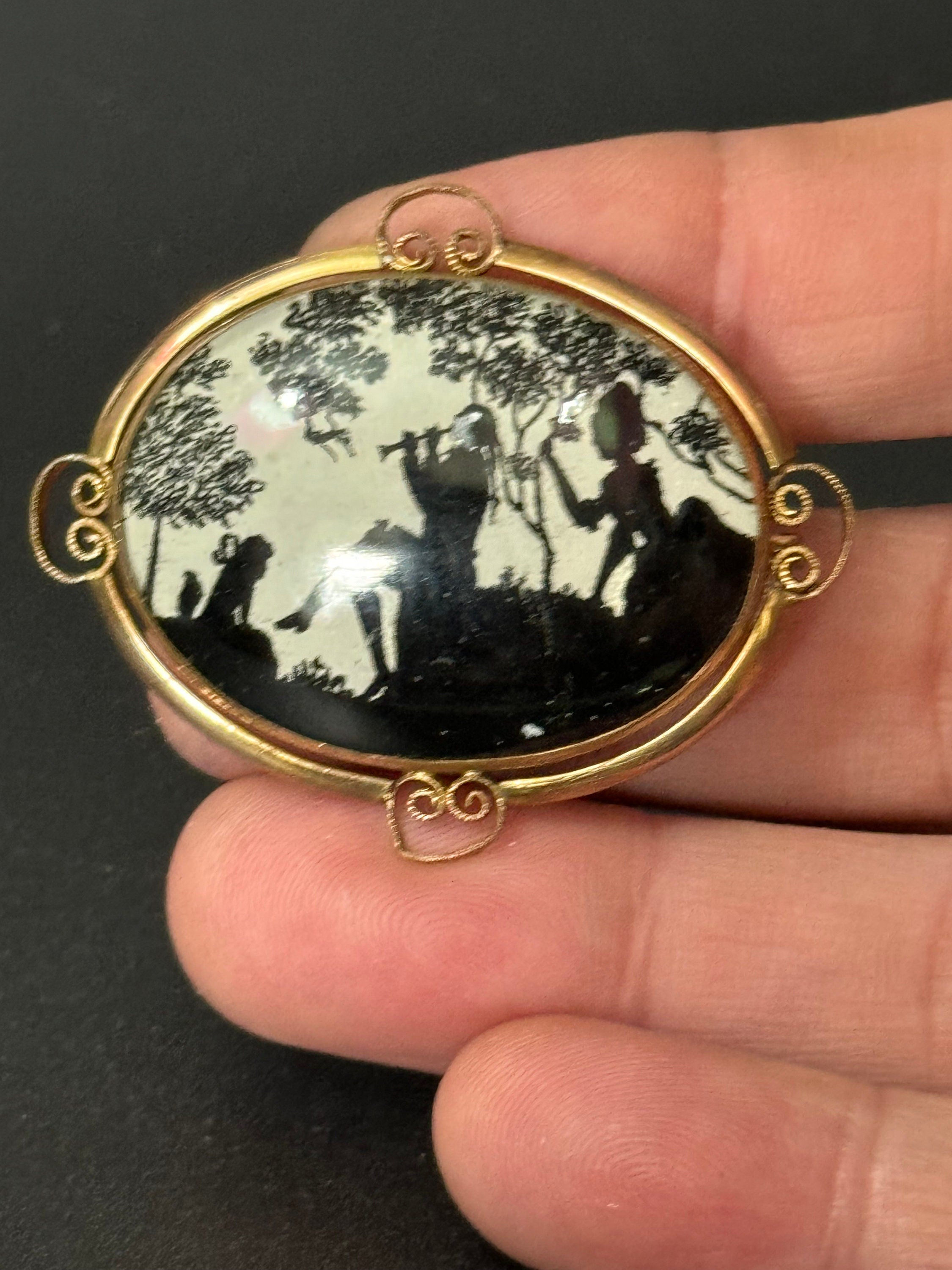 Vintage gold tone Pinchbeck oval silhouette brooch with stylised art deco piper lady and children