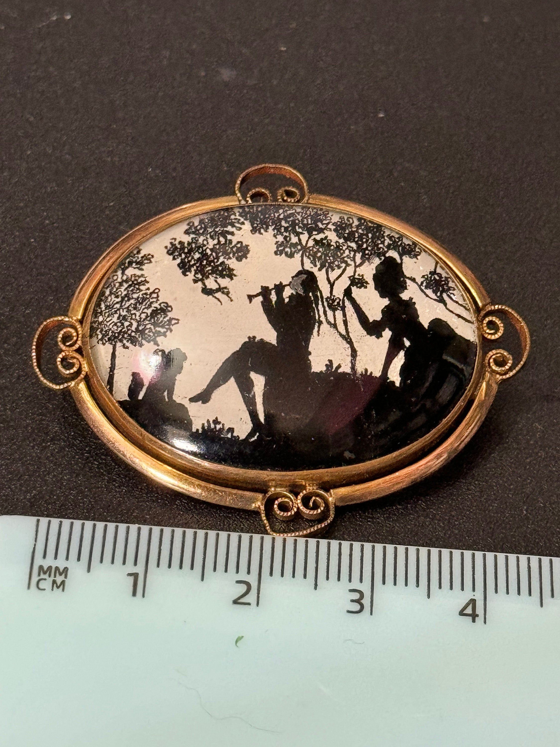 Vintage gold tone Pinchbeck oval silhouette brooch with stylised art deco piper lady and children