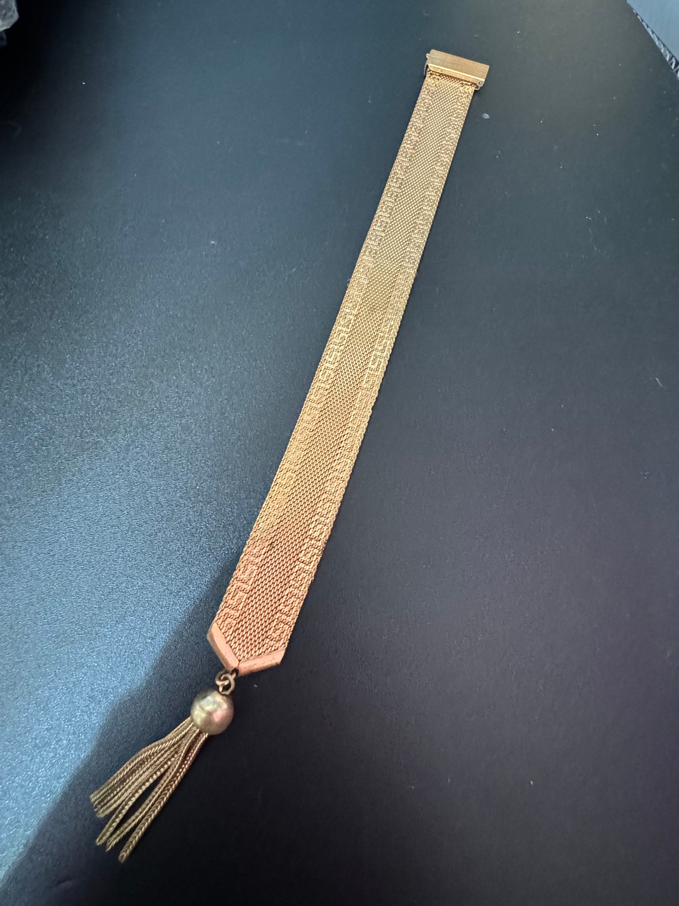 1970s Greek key design gold tone articulated flat 2cm wide tassel bracelet 19cm