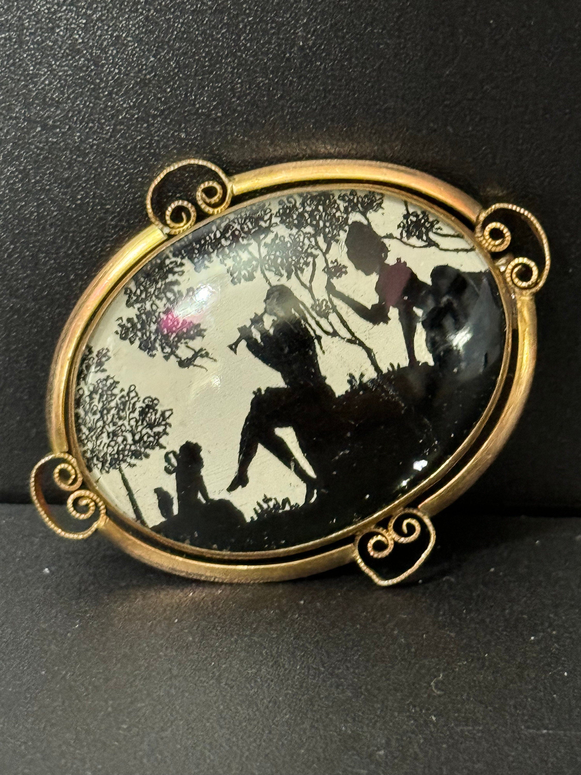 Vintage gold tone Pinchbeck oval silhouette brooch with stylised art deco piper lady and children