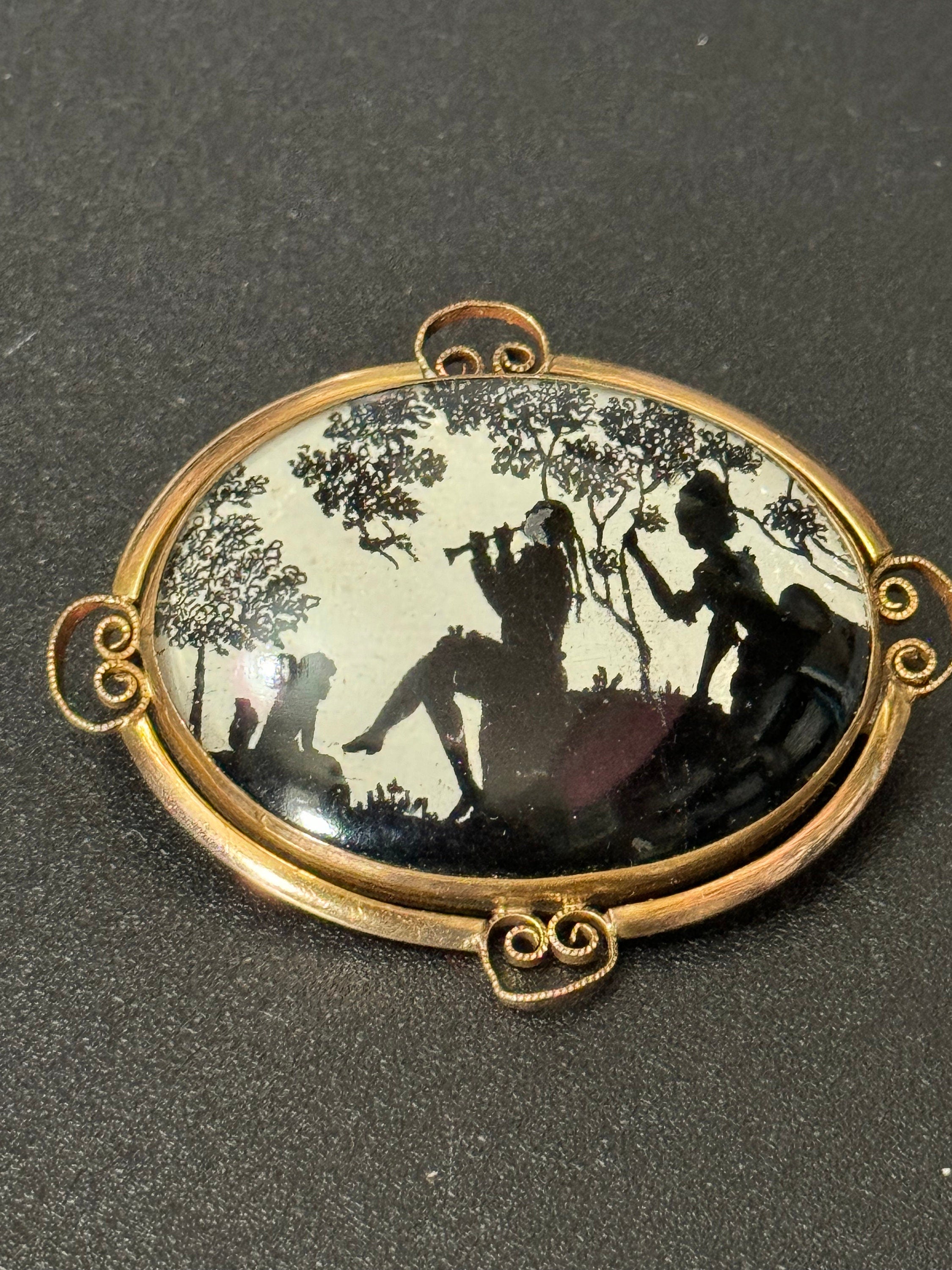 Vintage gold tone Pinchbeck oval silhouette brooch with stylised art deco piper lady and children
