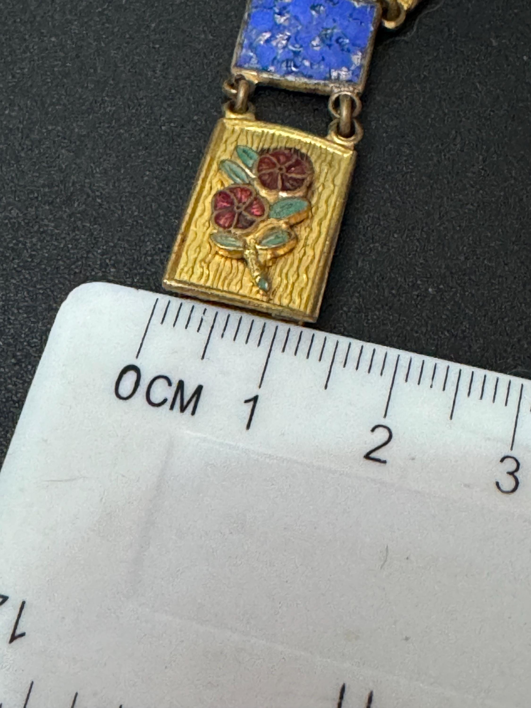 Antique brass enamelled panel link bracelet with blue gold and flower details