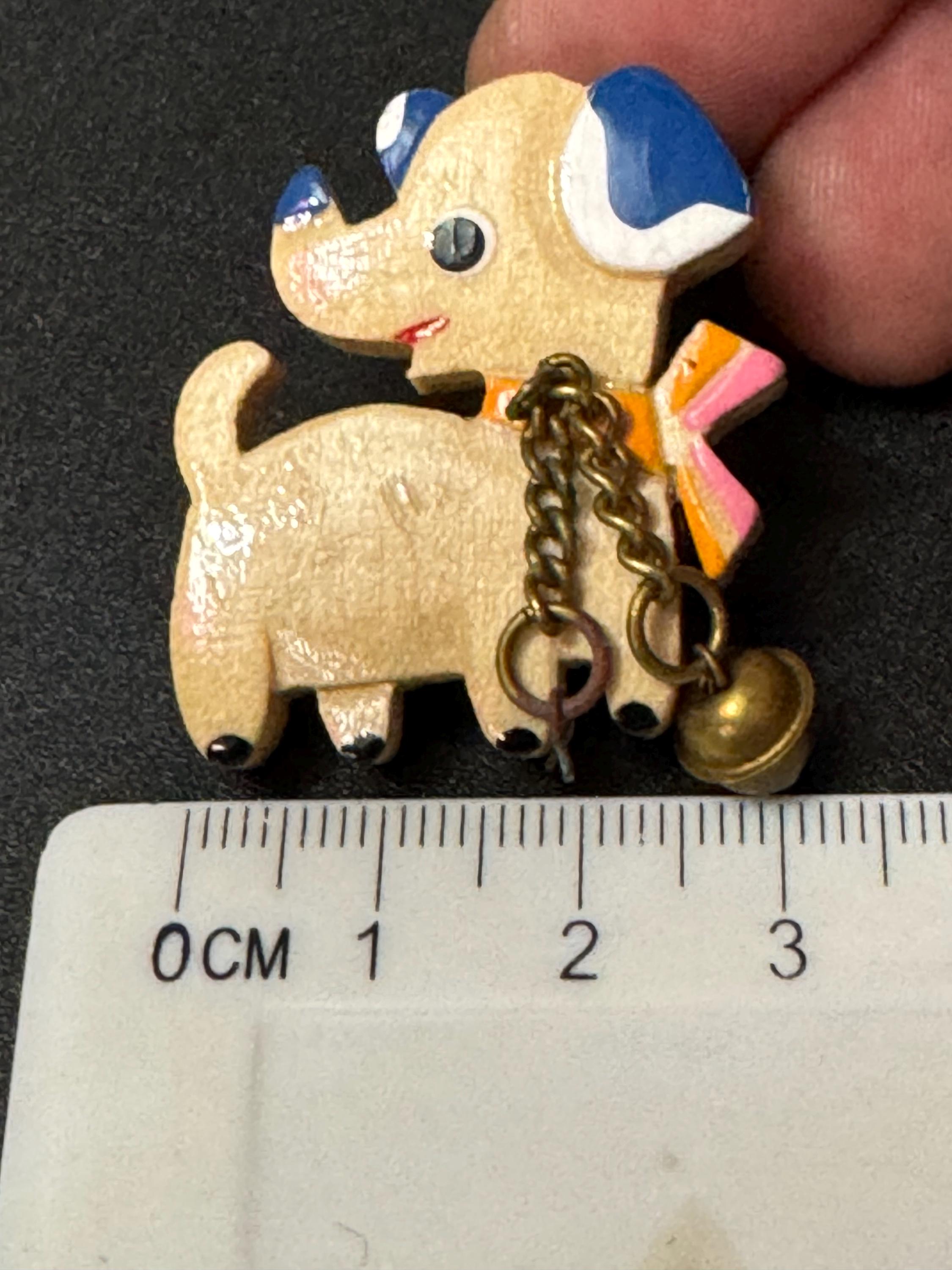 Early wooden light brown novelty dog brooch, stamped foreign with brass bells mid century