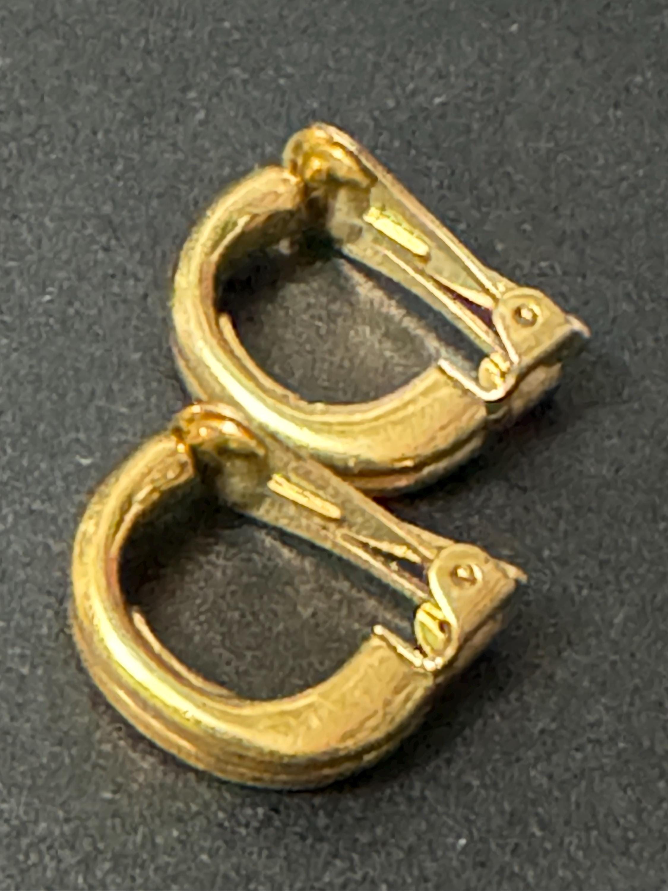 Signed David Grau gold tone half hoop clip on earrings, designer
