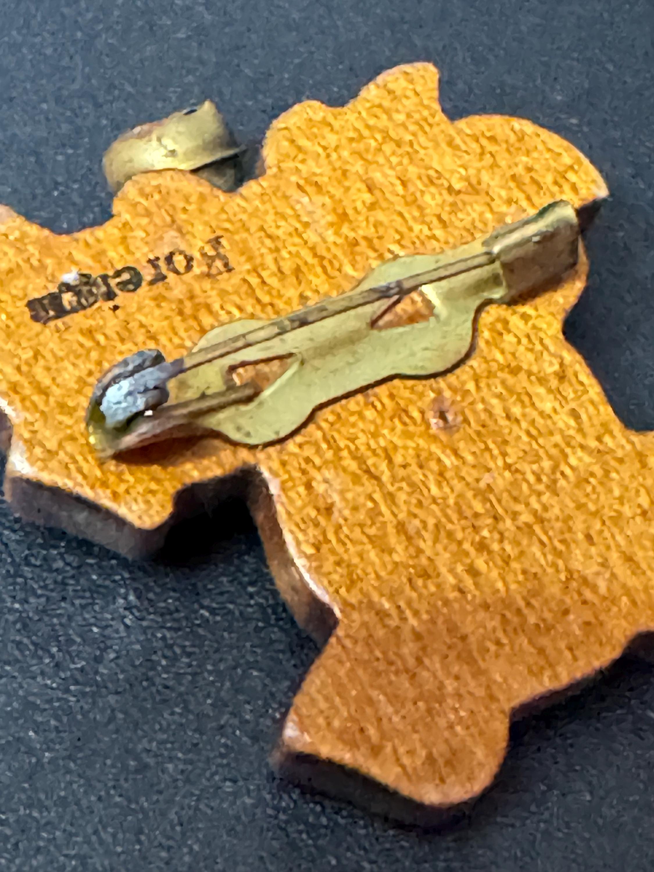 Early wooden brown novelty dog brooch, stamped foreign with brass bells mid century