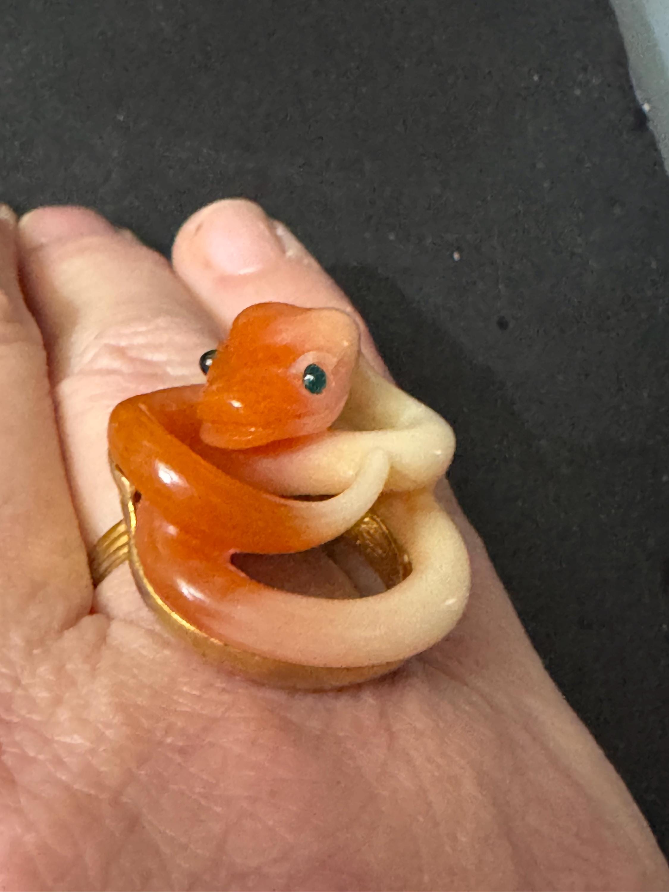 Vintage gold tone orange plastic curled snake ring with emerald eyes adjustable