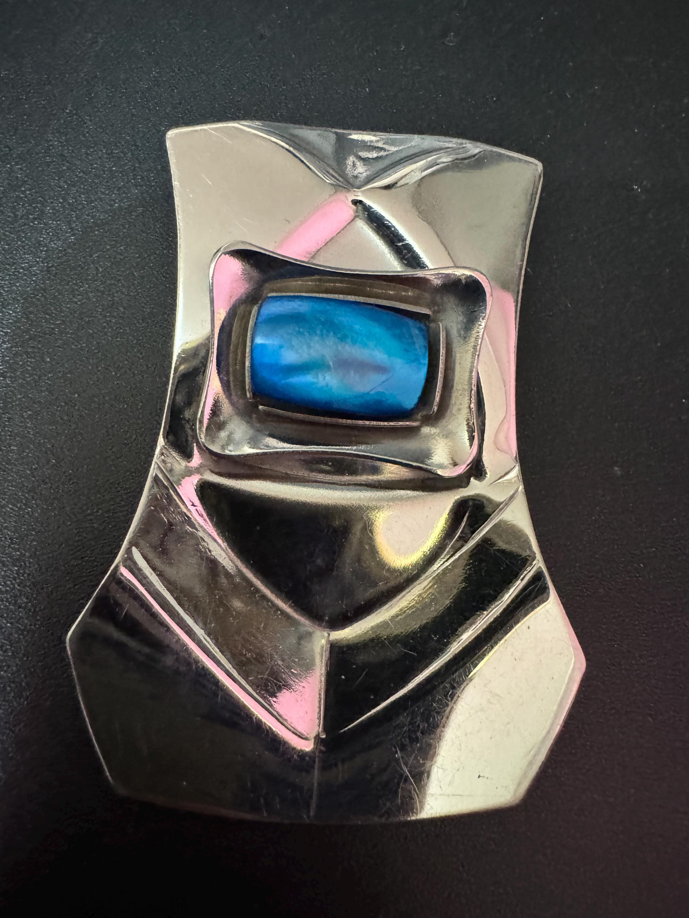 Signed Jason designs Modernist stainless steel atomic brooch with bright blue cabochon 1970s metal from Sheffield