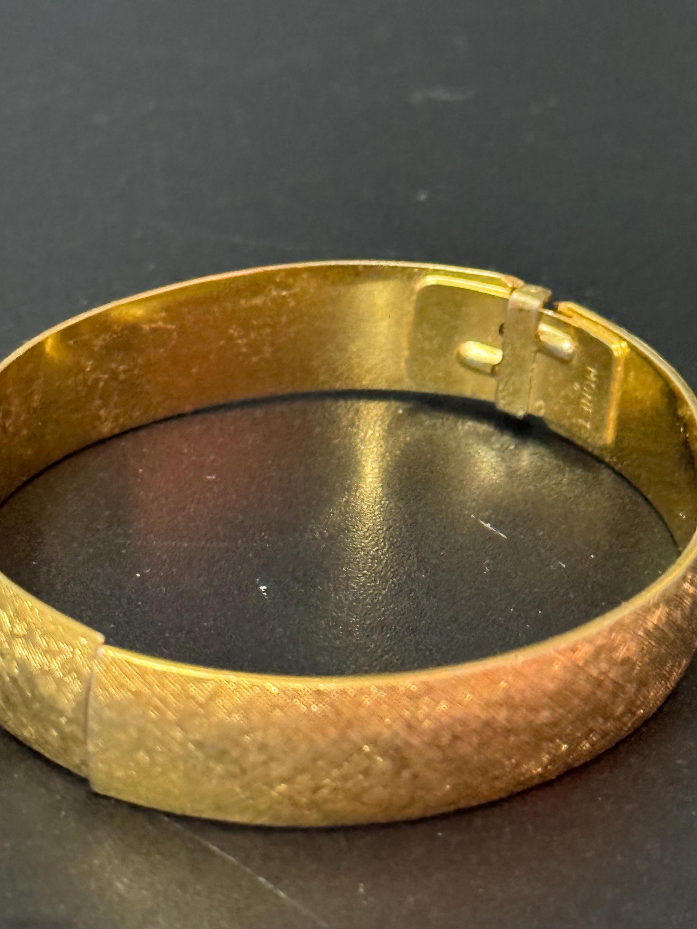 designer MONET signed brushed gold tone 1cm wide hinged clamper bangle bracelet