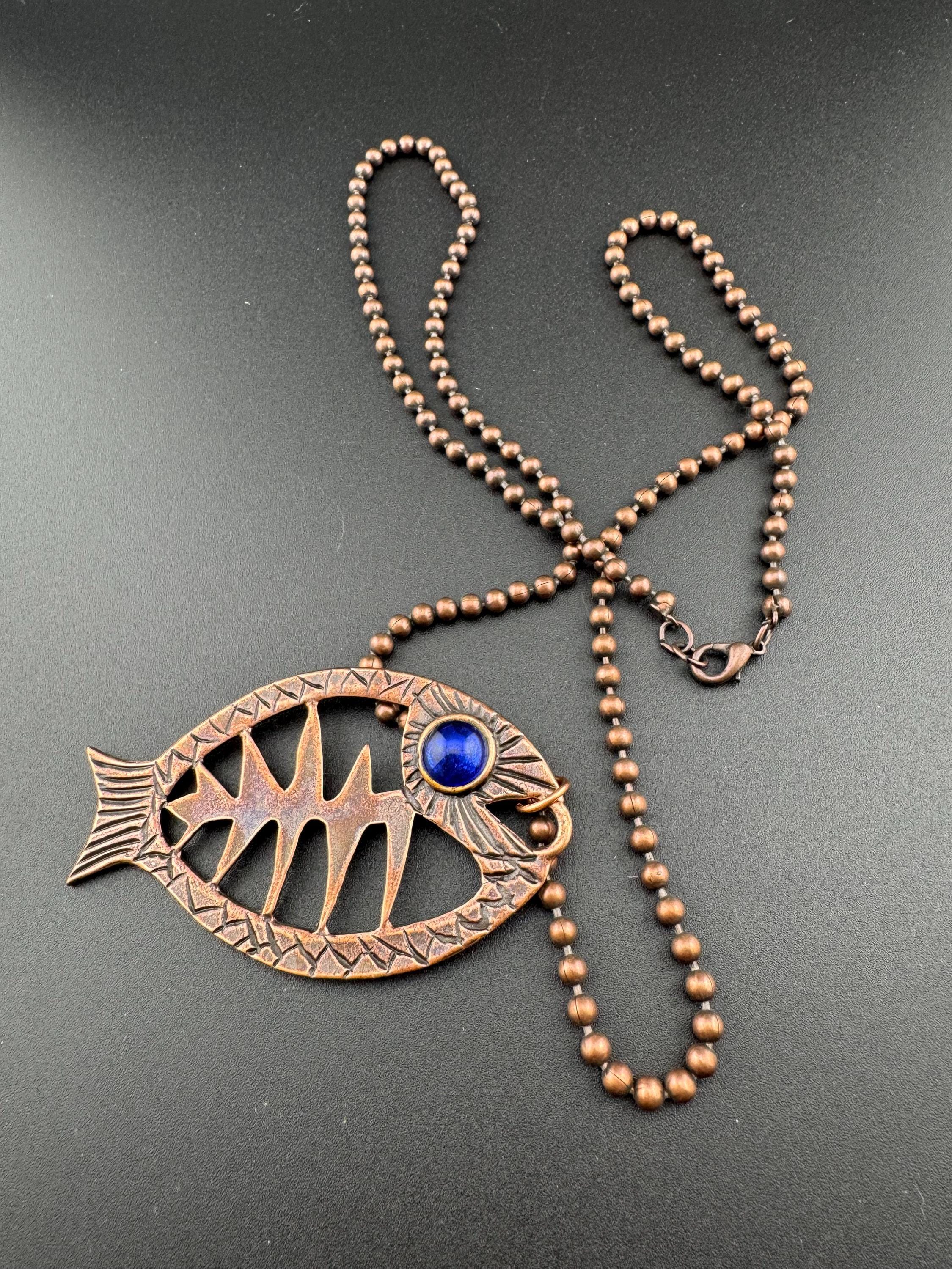 Vintage c 1980s copper tone fish pendant on a 75cm ball bead long chain necklace, blue glass eyes on both sides
