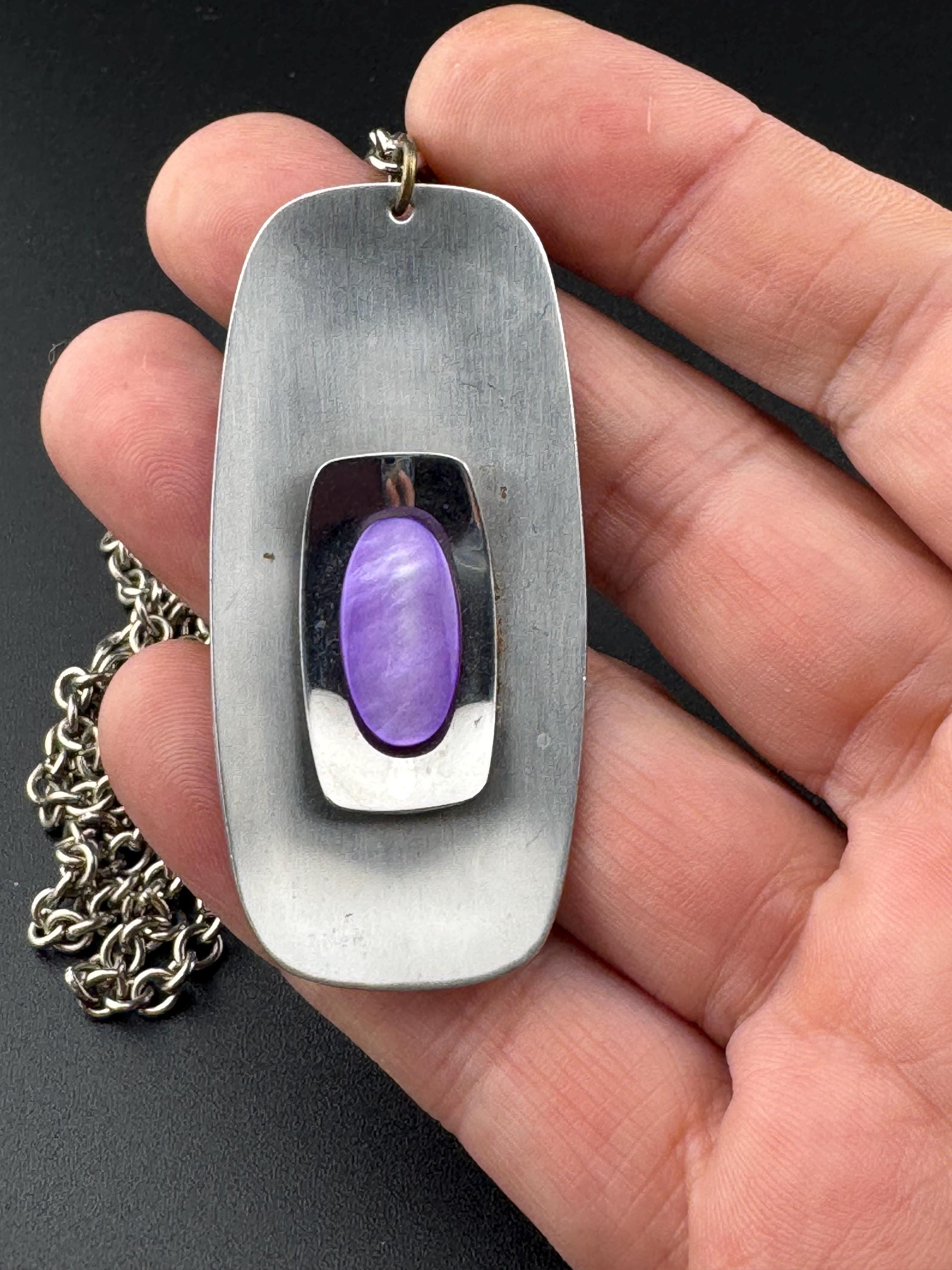 Vintage Modernist silver tone stainless steel pendant necklace and chain set with central purple glass cabochon 1970s