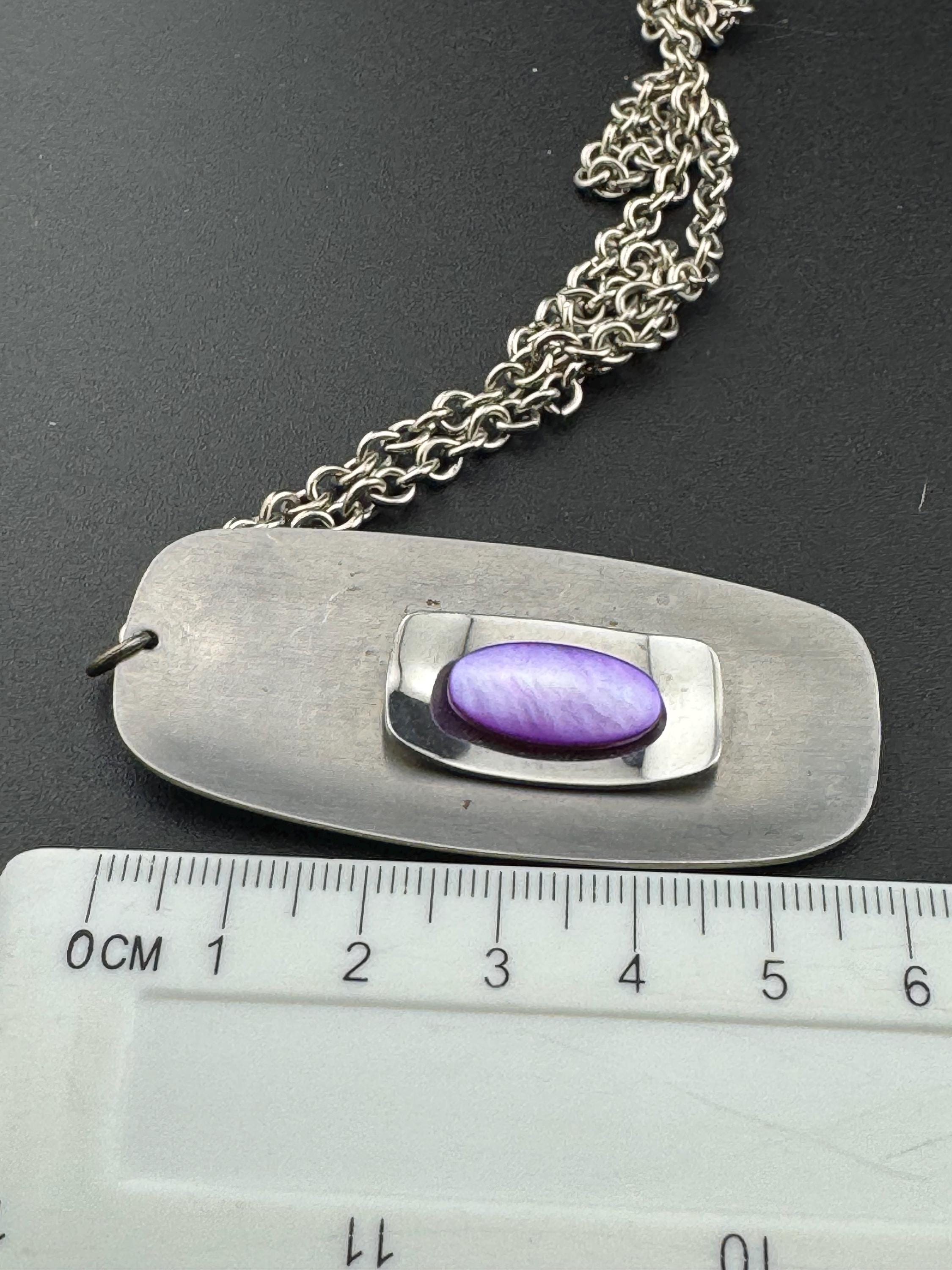 Vintage Modernist silver tone stainless steel pendant necklace and chain set with central purple glass cabochon 1970s
