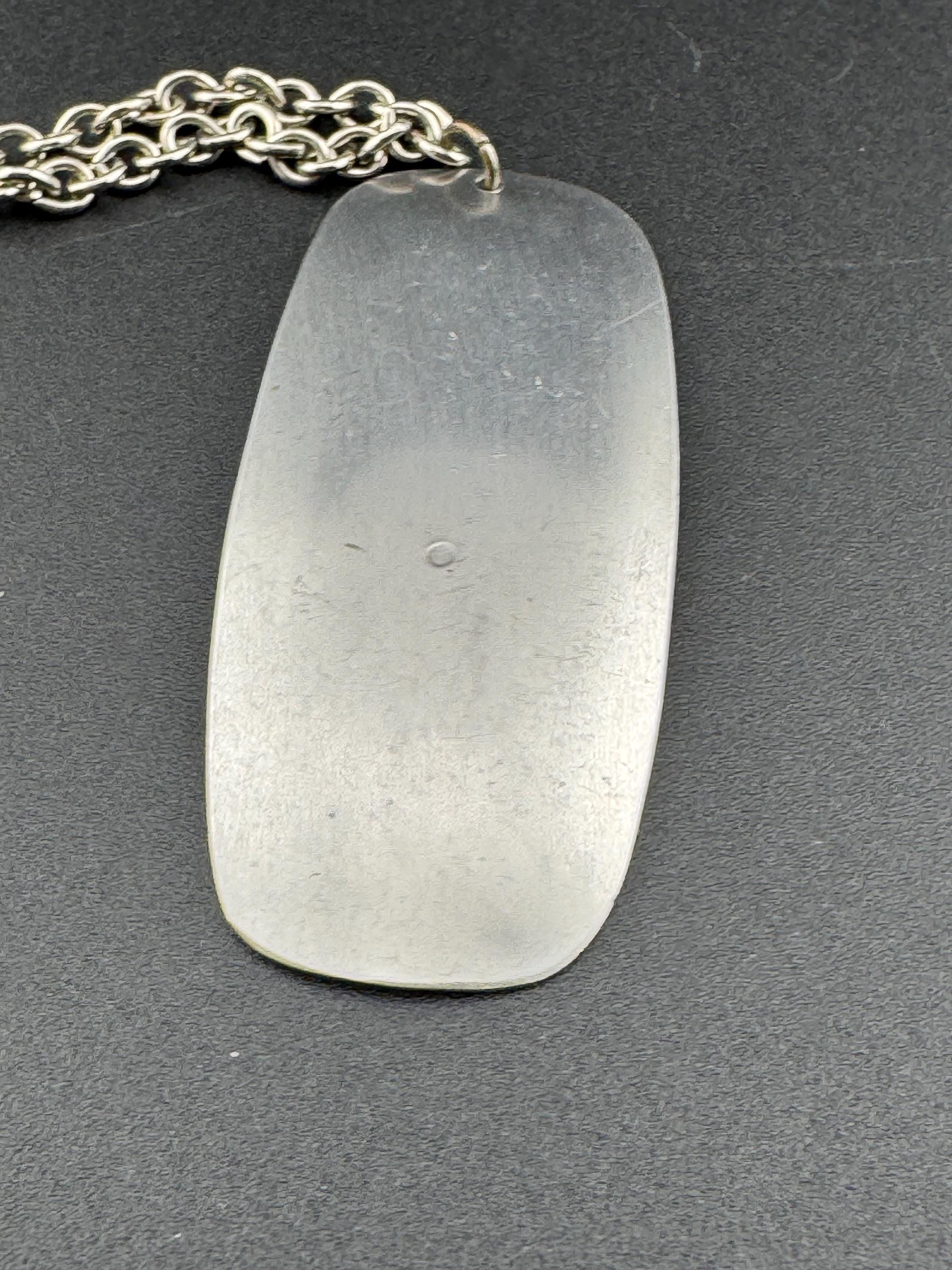 Vintage Modernist silver tone stainless steel pendant necklace and chain set with central purple glass cabochon 1970s