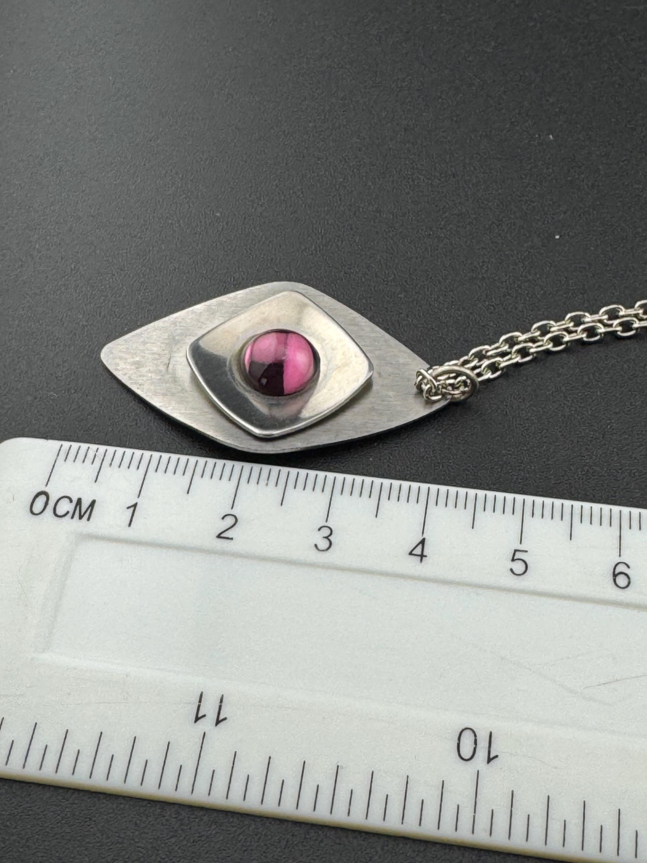 Vintage Modernist silver tone stainless steel pendant necklace and chain set with central purple glass cabochon 1970s