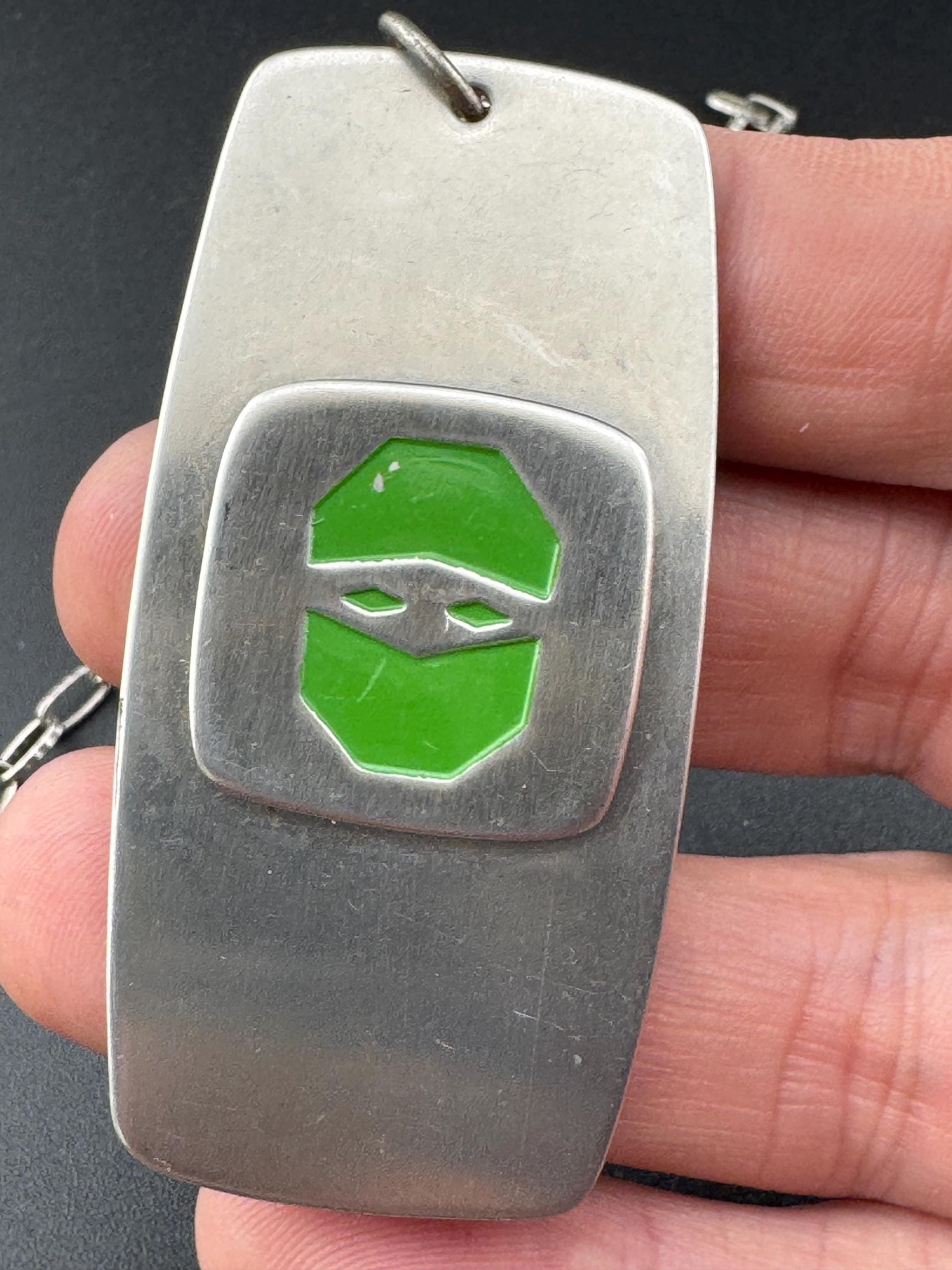 Vintage Modernist silver tone stainless steel pendant necklace and chain set with central bright green design 1970s