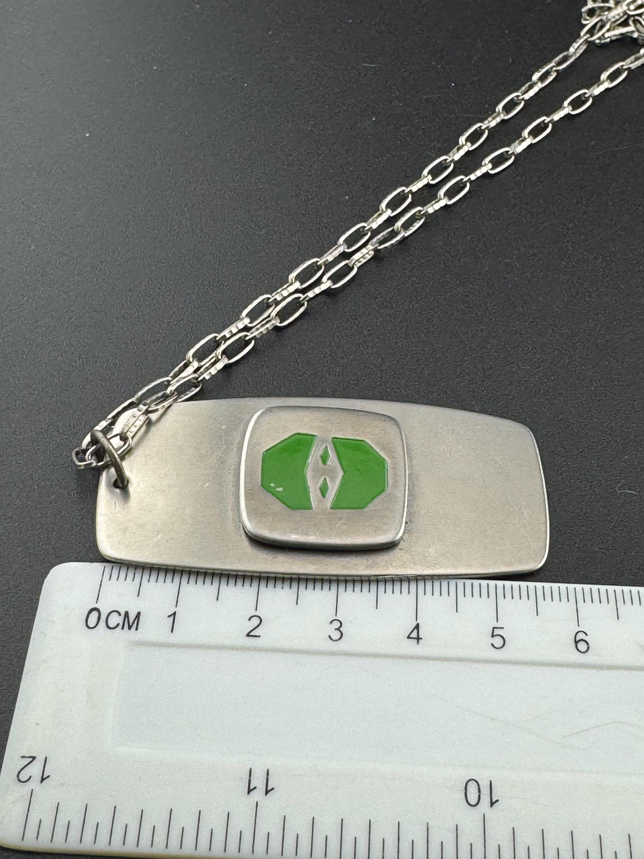 Vintage Modernist silver tone stainless steel pendant necklace and chain set with central bright green design 1970s