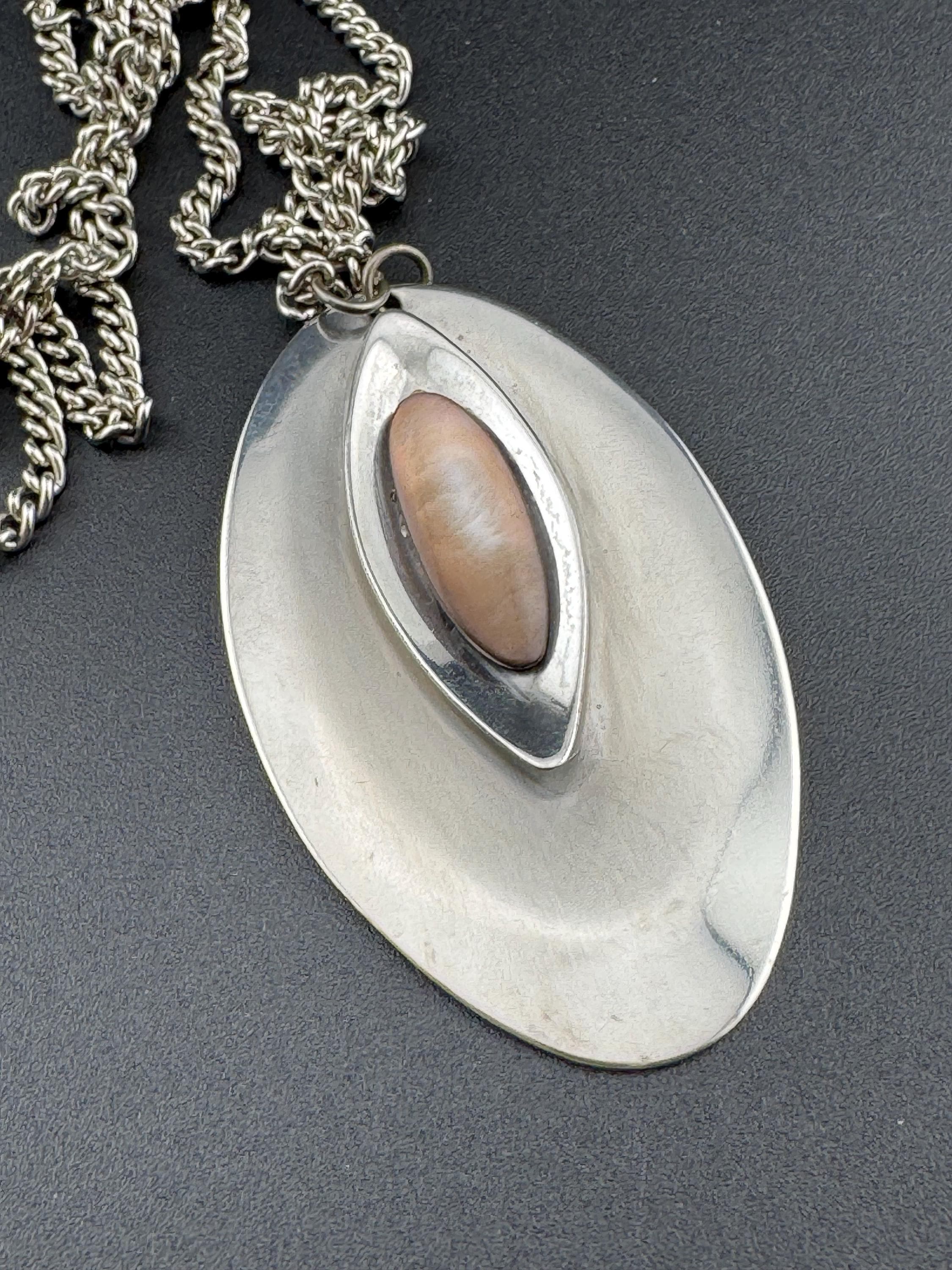 Vintage Modernist silver tone stainless steel pendant necklace and chain set with central pink taupe cabochon 1970s