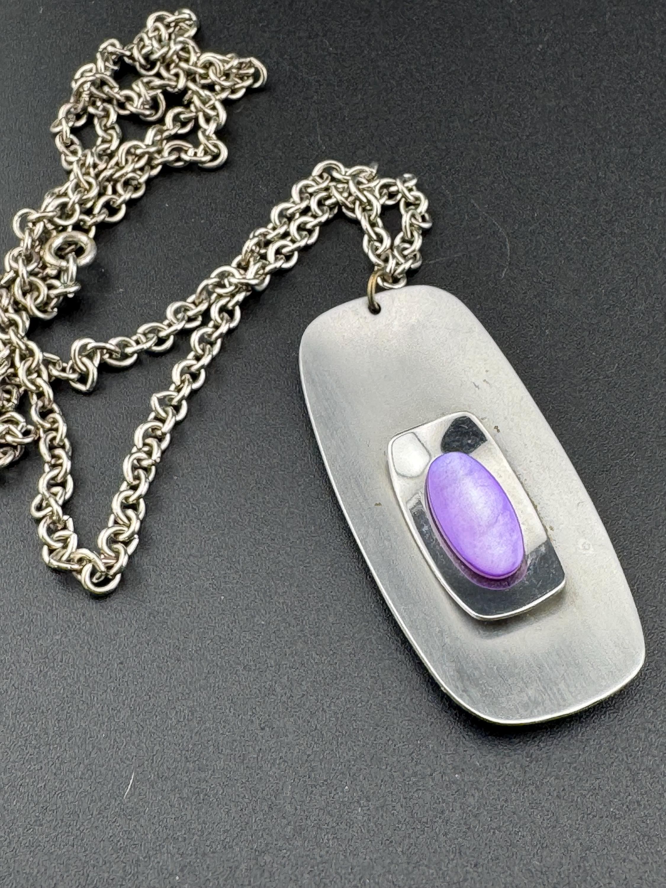 Vintage Modernist silver tone stainless steel pendant necklace and chain set with central purple glass cabochon 1970s
