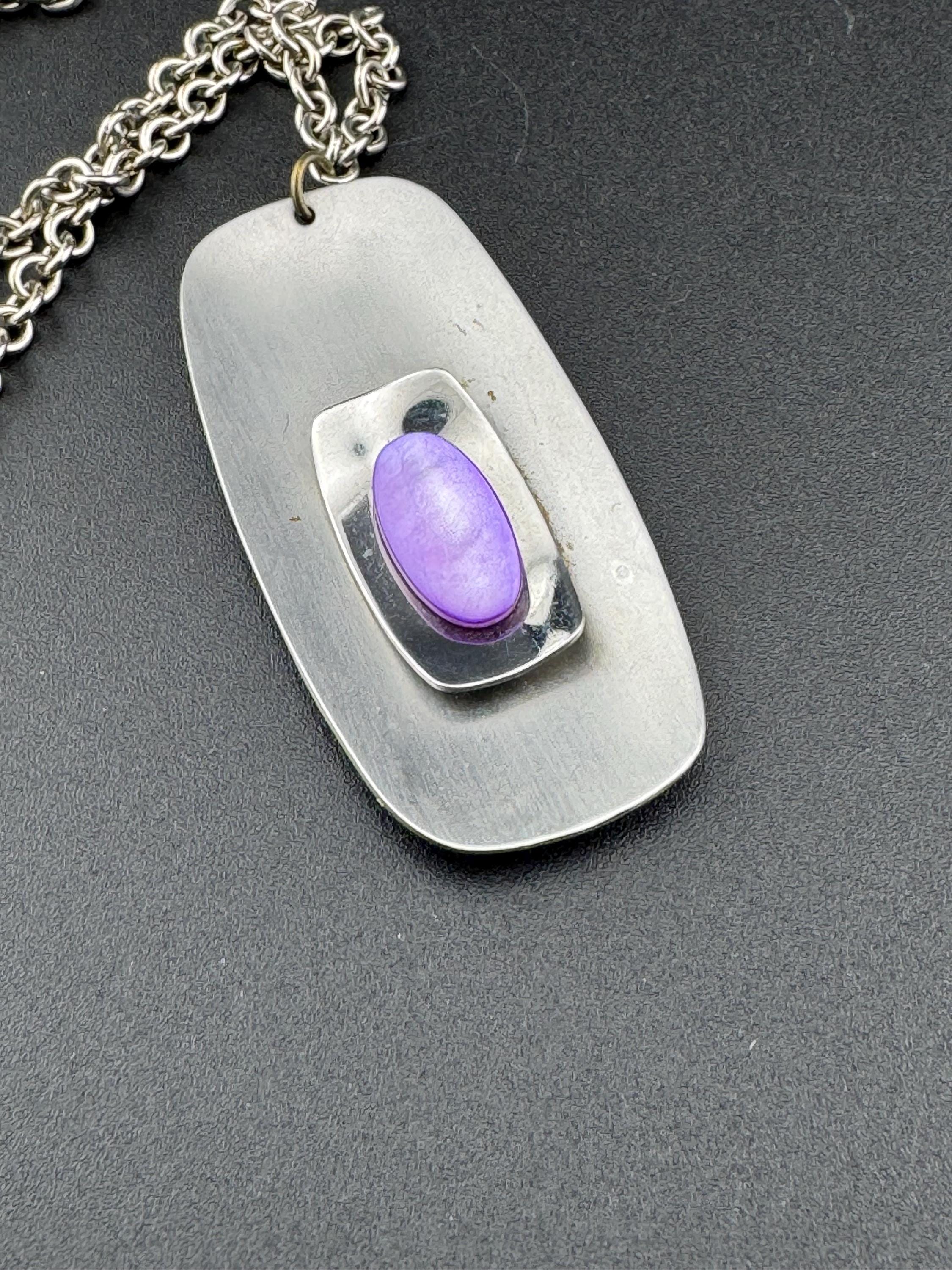 Vintage Modernist silver tone stainless steel pendant necklace and chain set with central purple glass cabochon 1970s