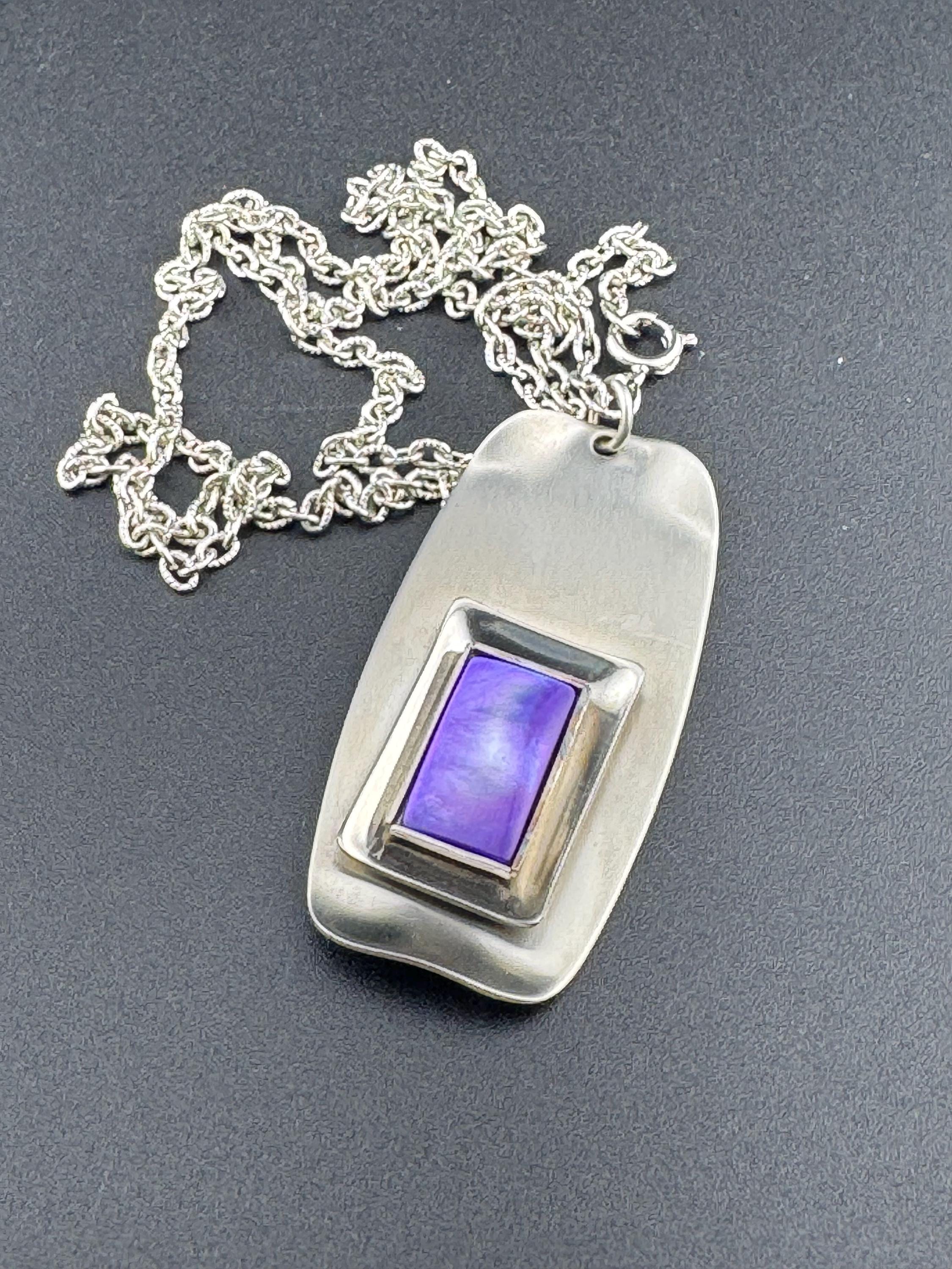 Signed Lord python Vintage Modernist silver tone stainless steel pendant necklace and chain set with central purple glass cabochon 1970s