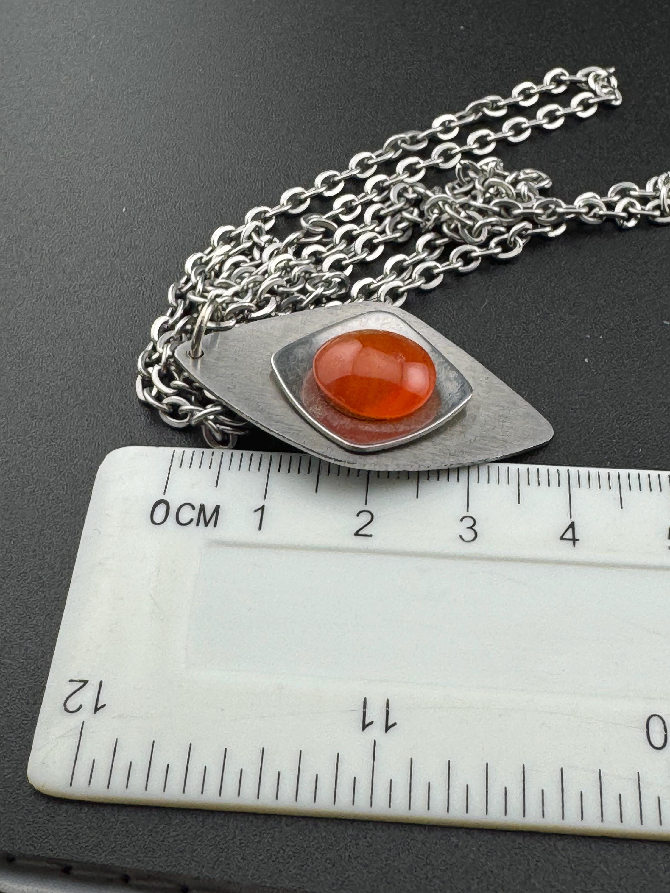 Vintage Modernist silver tone stainless steel pendant necklace and chain set with central orange glass cabochon 1970s