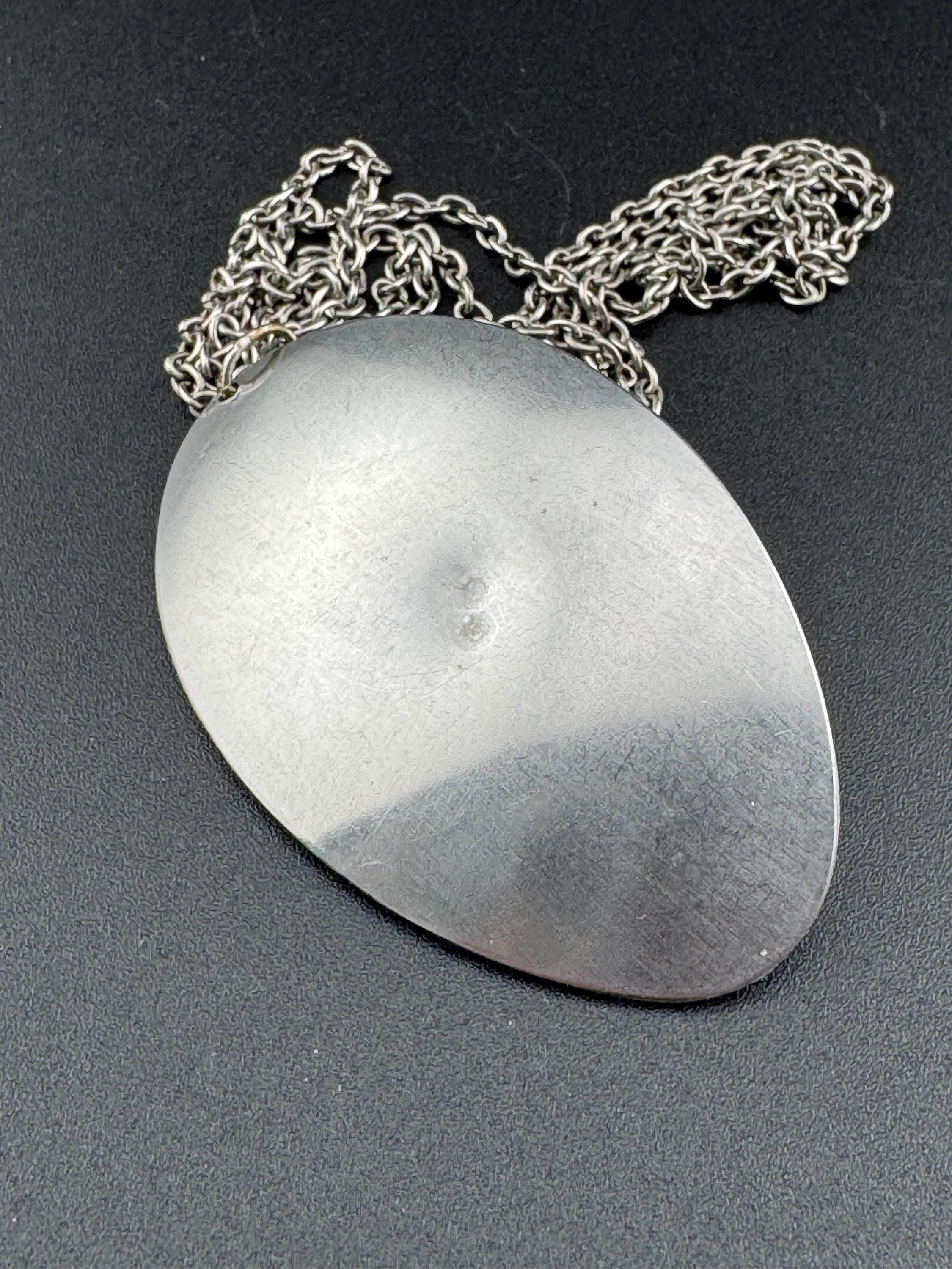 Vintage Modernist silver tone stainless steel pendant necklace and chain set with central purple crackle glass cabochon 1970s