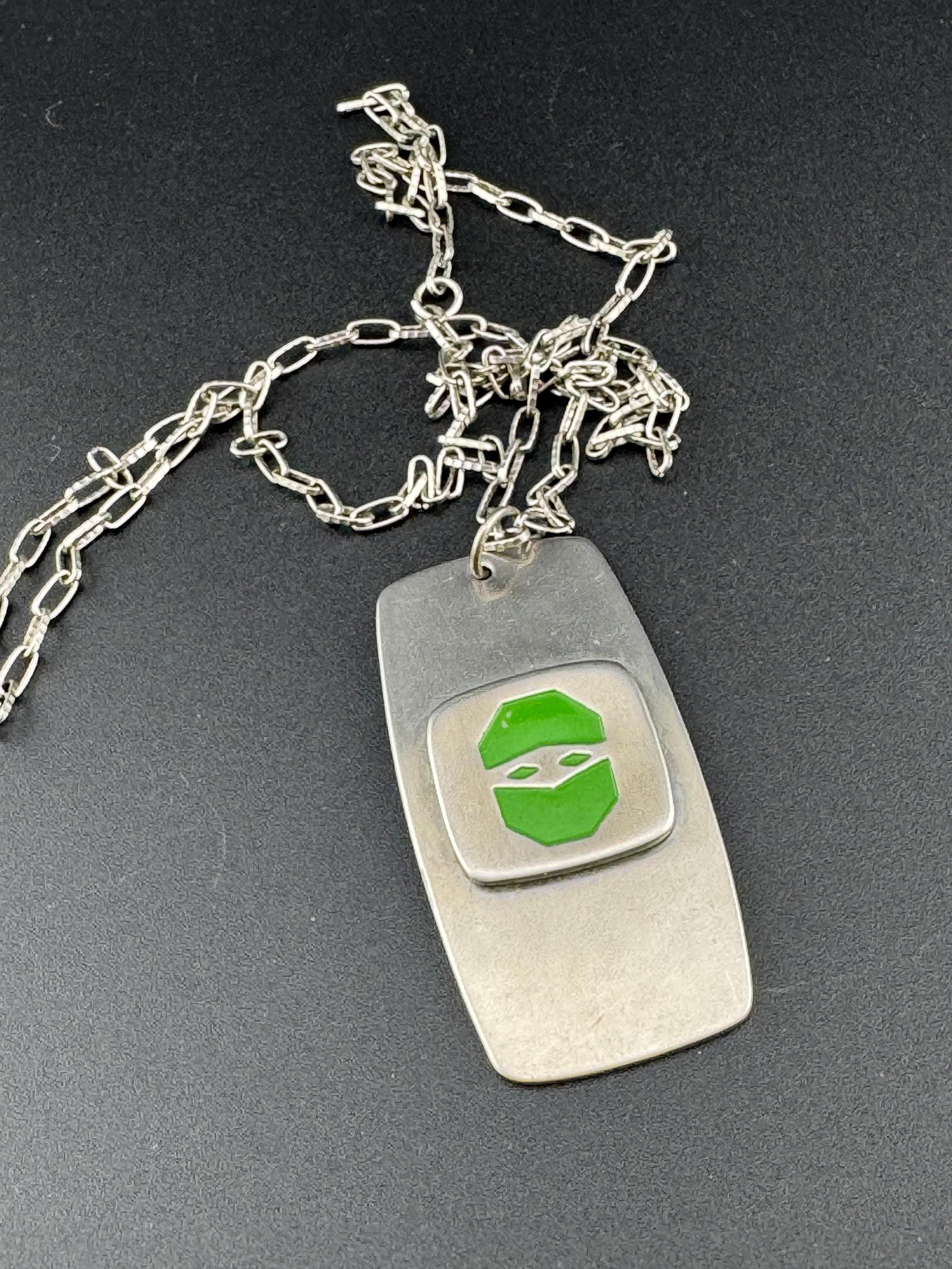 Vintage Modernist silver tone stainless steel pendant necklace and chain set with central bright green design 1970s