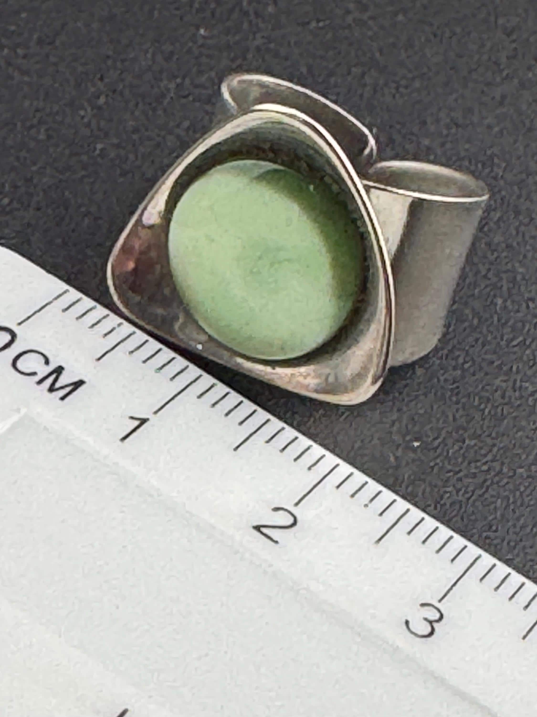 1970s vintage stainless steel silver metal adjustable ring with central green cabochon mid century