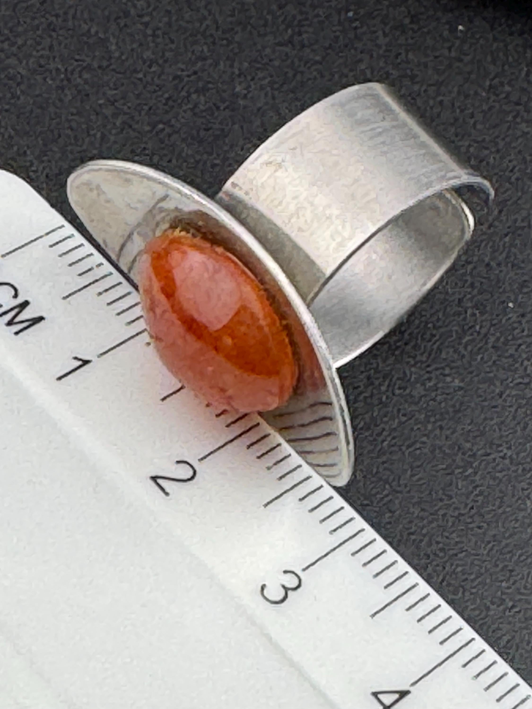 1970s vintage stainless steel silver metal adjustable ring with central orange cabochon mid century