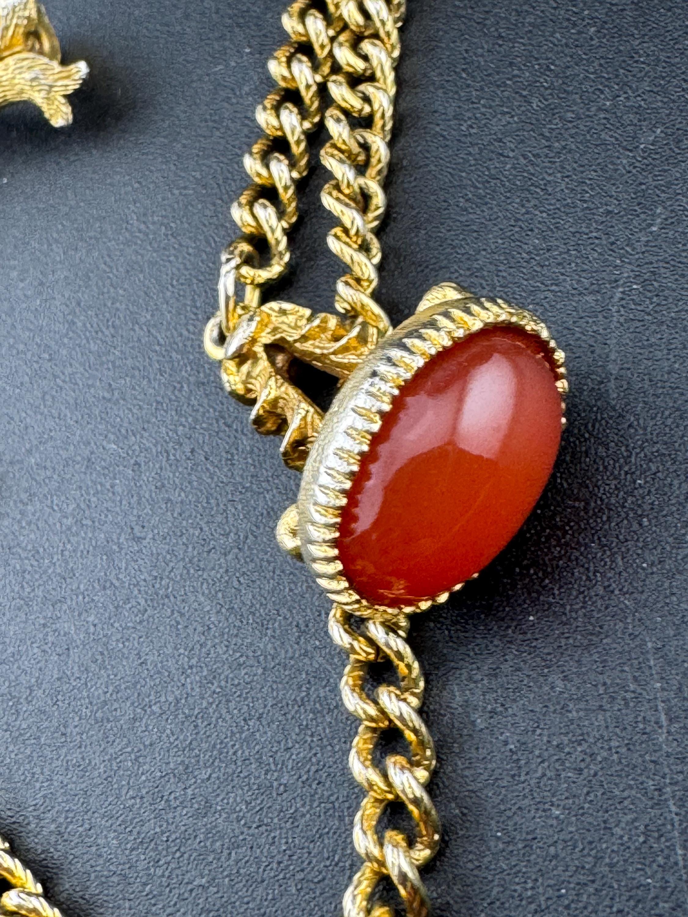 vintage double brooch gold tone with green gem set shield and faux carnelian cabochon jumper guards cloak clips