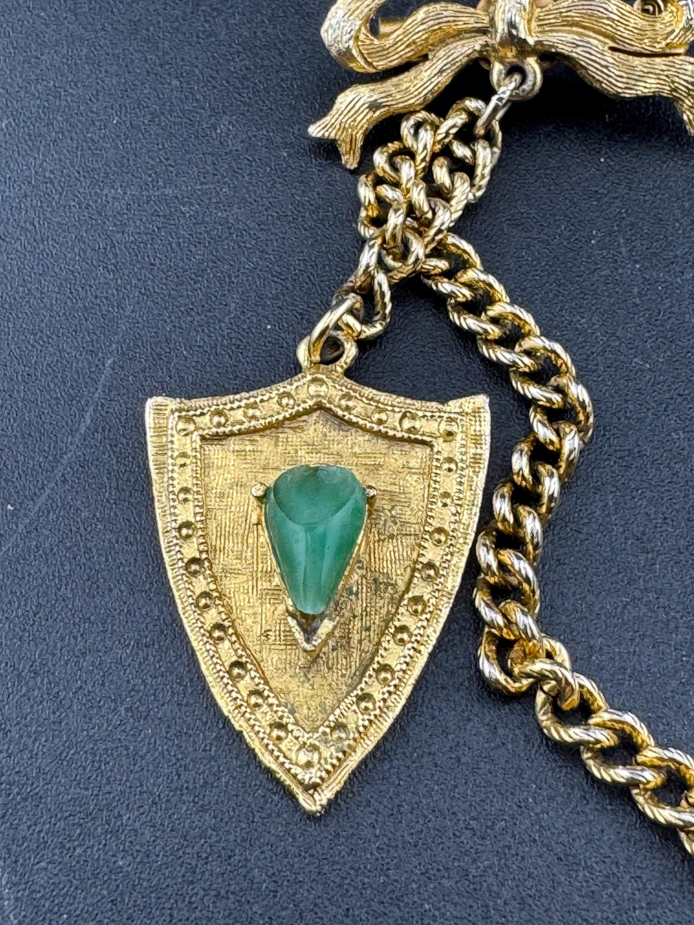 vintage double brooch gold tone with green gem set shield and faux carnelian cabochon jumper guards cloak clips
